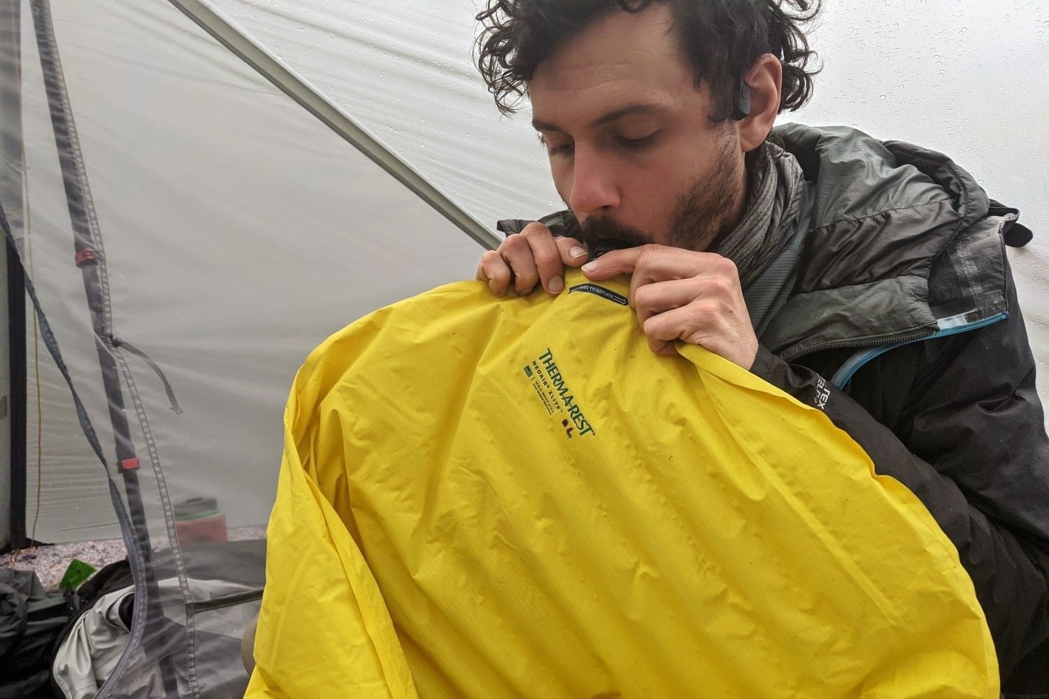 A backpacker blowing up his Therm-a-Rest NeoAir XLite sleeping pad