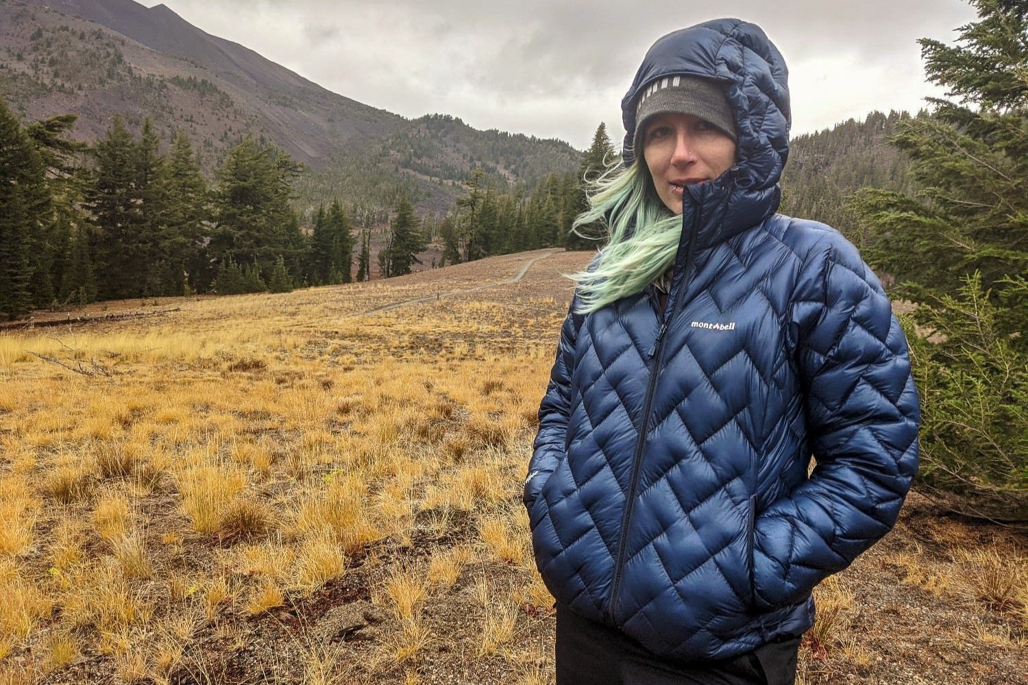A backpacker wearing the Montbell Plasma 1000 down jacket in the Three Sisters Wilderness