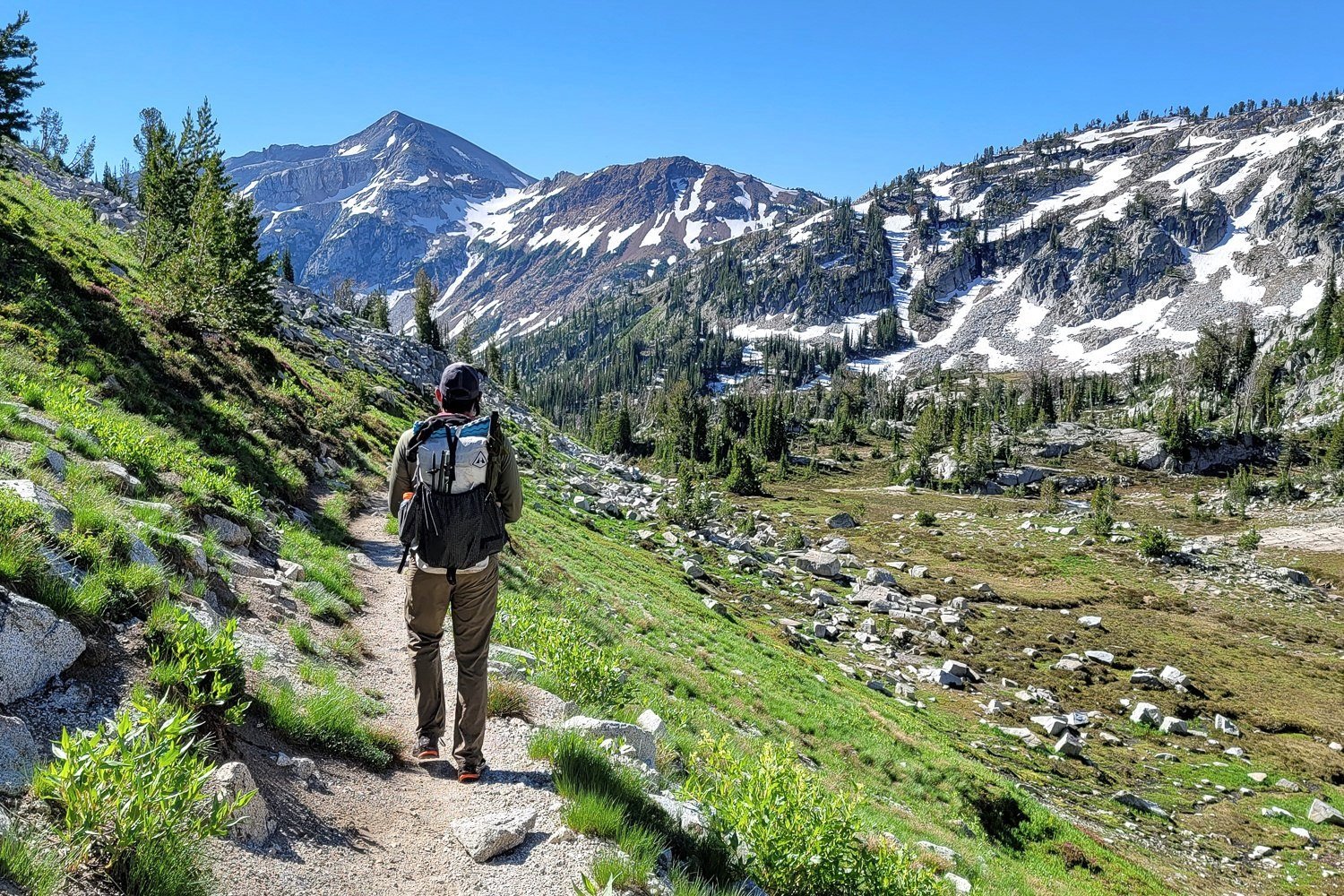 A backpacker hiking in the Eagle Cap Lakes Basin towards Moccasin Lake