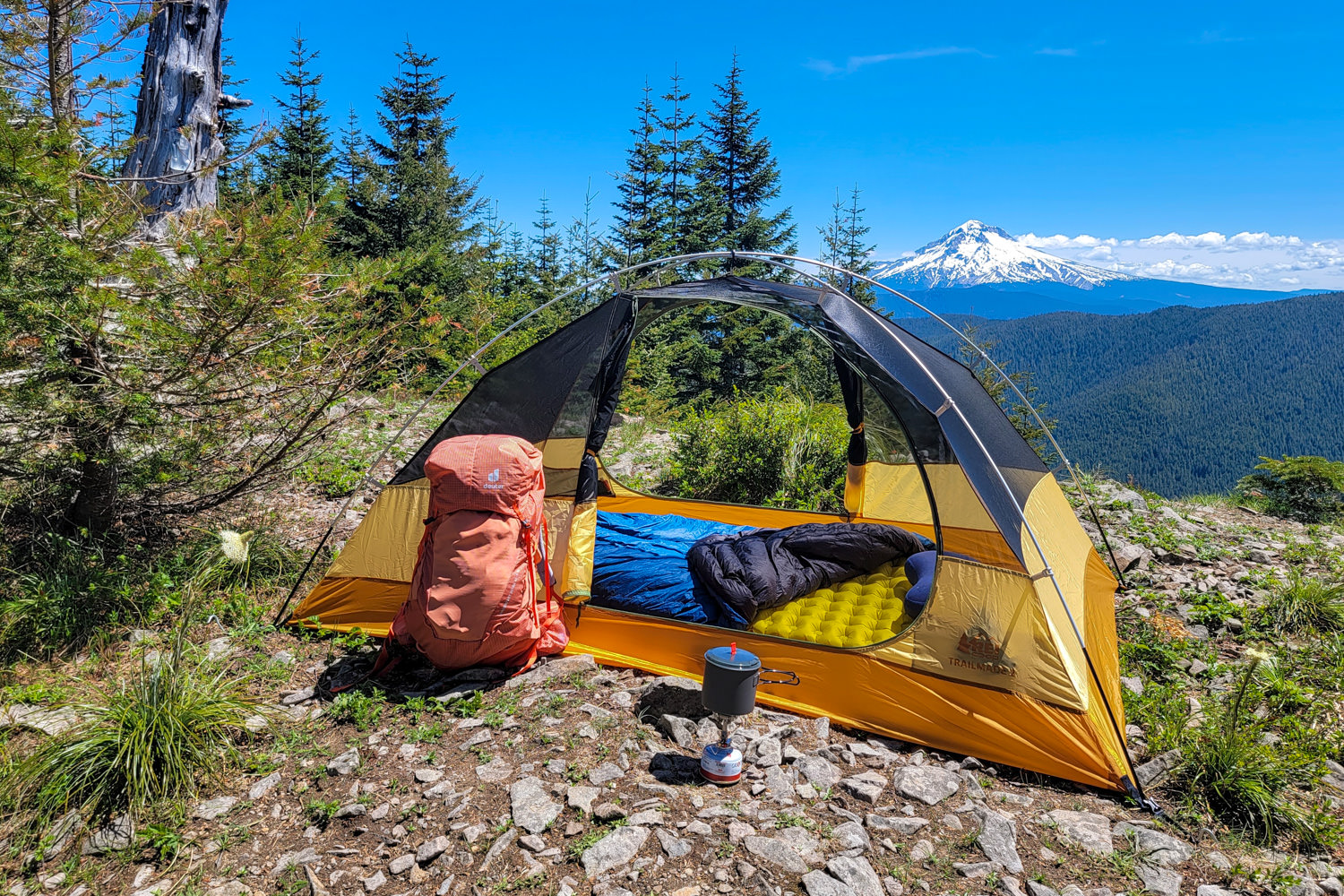The REI Trailmade 2 backpacking tent set up on a ridge with a view of Mt. Hood in the background