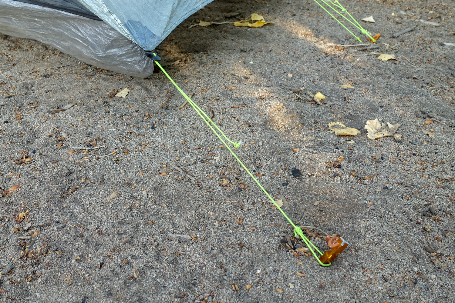 a closeup of the guyline staked out on the zpacks classic triplex backpacking tent