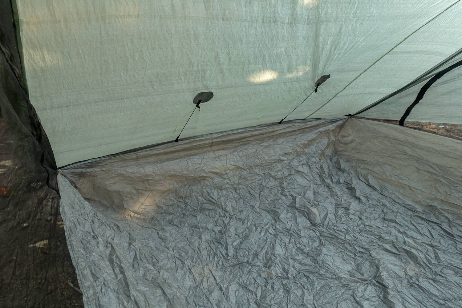 the inside view of the zpacks classic triplex ultralight backpacking tent with internal guylines to pull the exterior screen doors away from rain spray