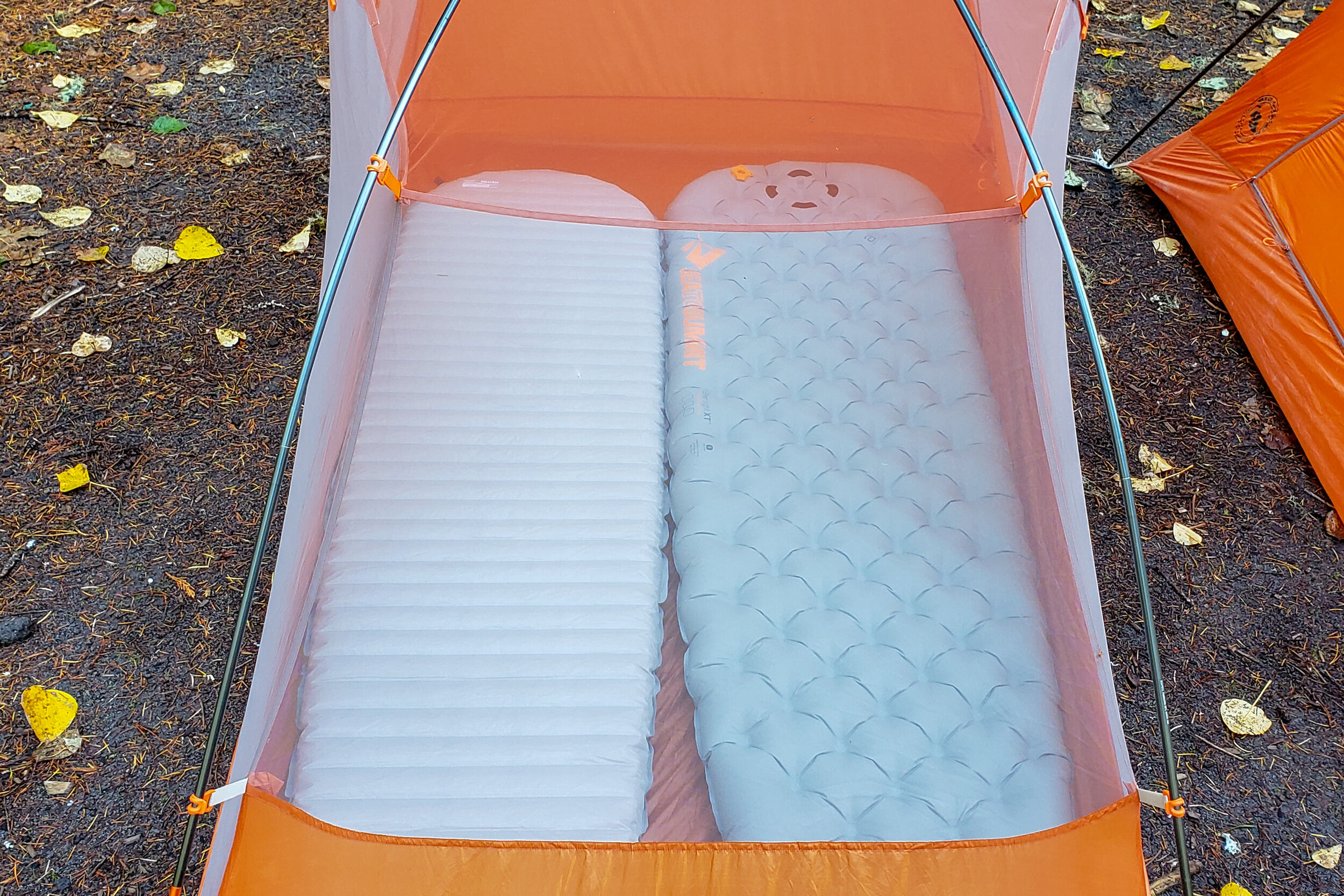 opting for a 2-person tent with regular-sized sleeping pads will save weight, but it may feel tight.