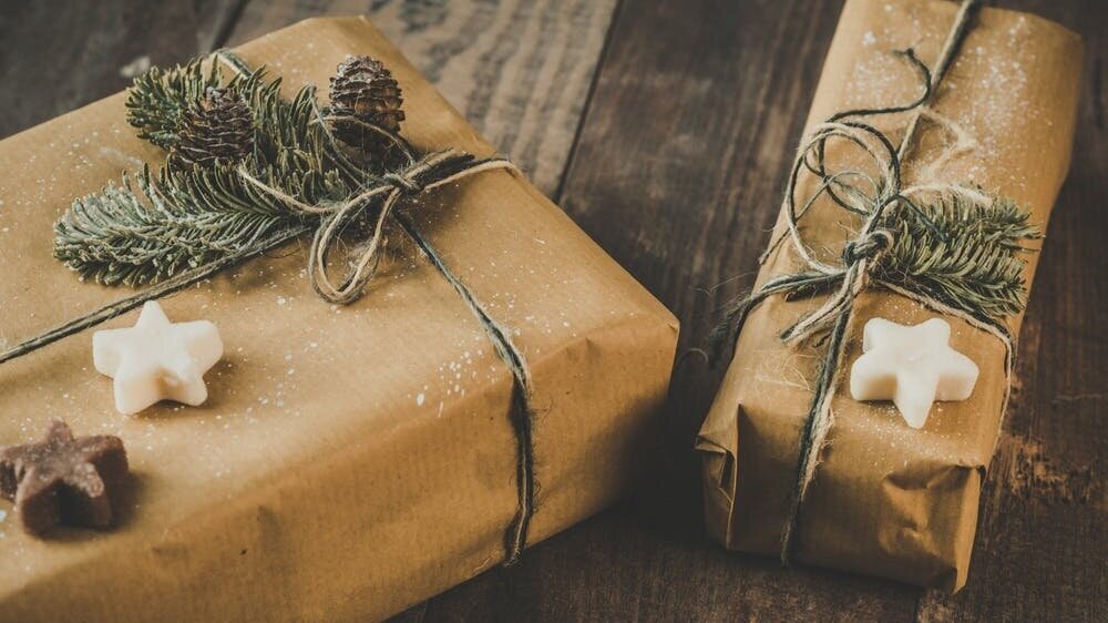 Use recycled paper bags as gift wrap and dress it up with tree scraps for a festive and sustainable option.
