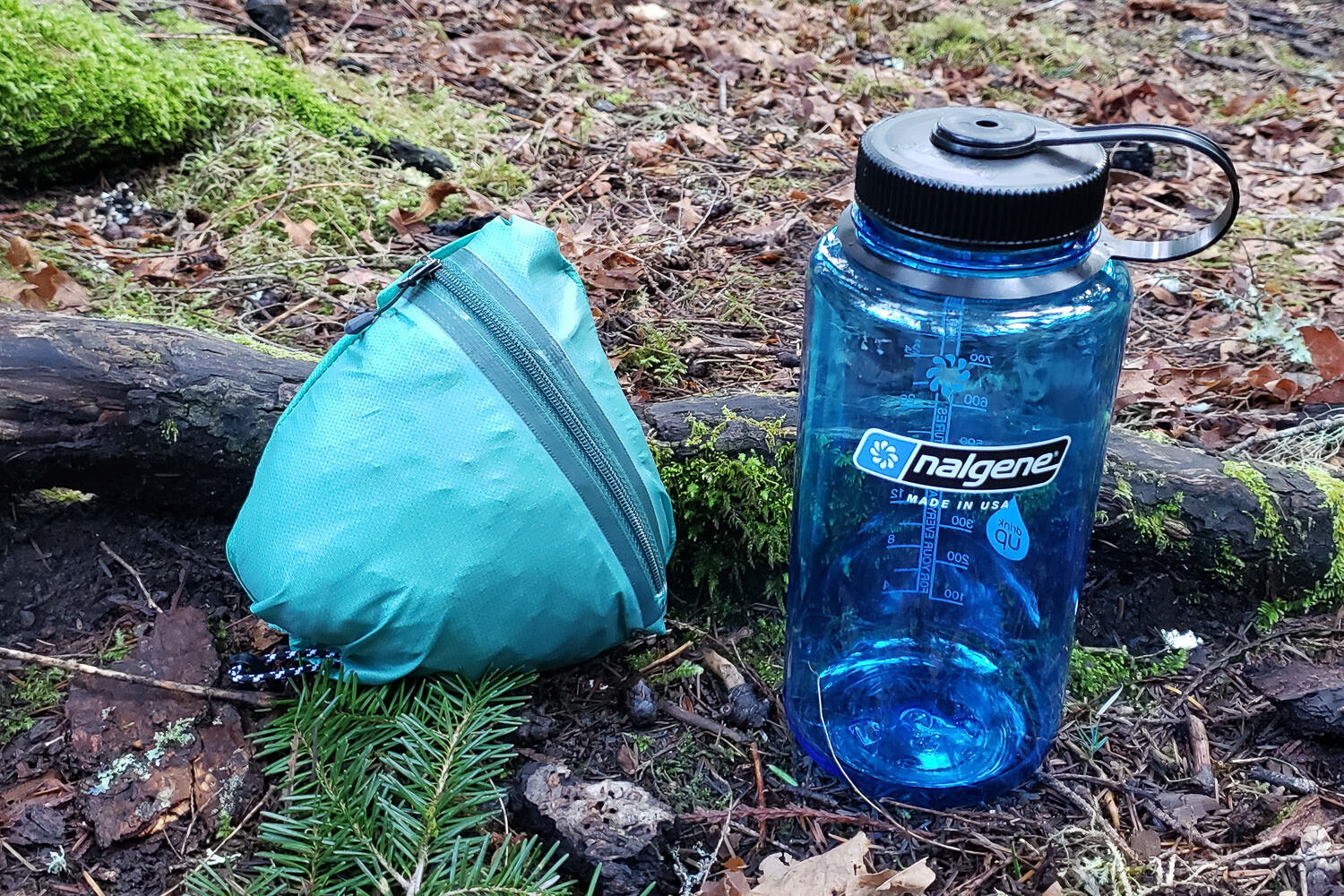 The Helium Rain Jacket next to a 1L water bottle