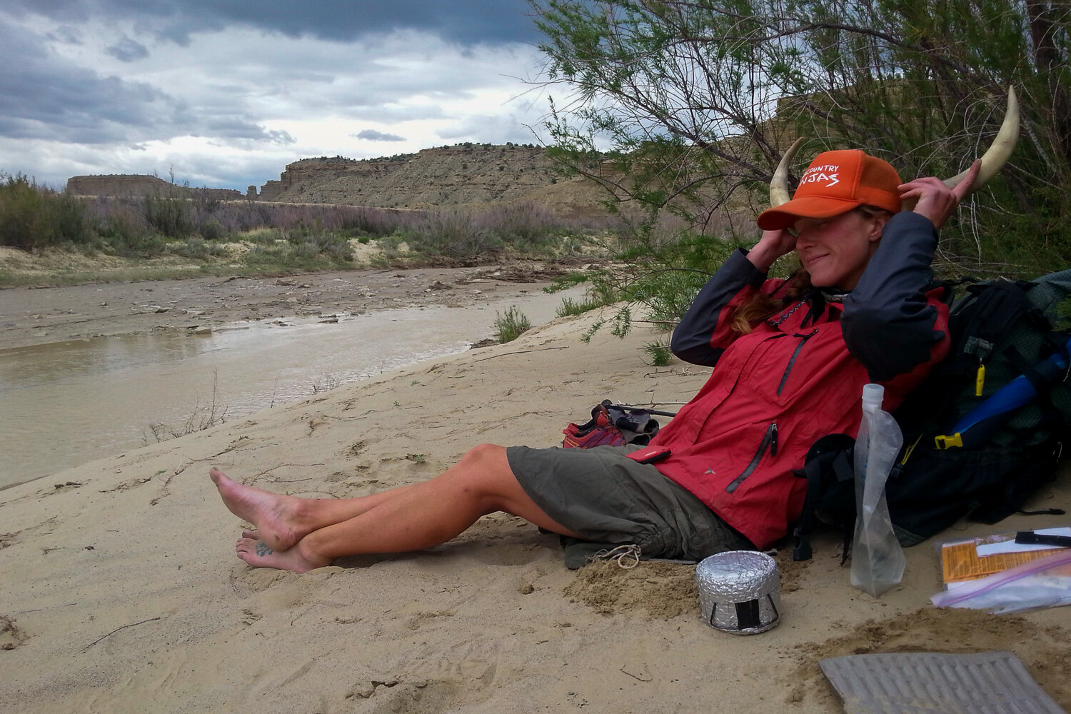 Posing for a photo with cow horns on a lunch break by a river