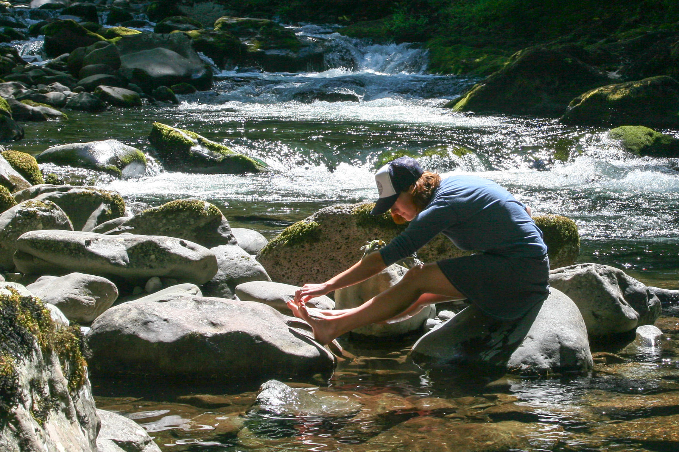 Taking a break on the Salmon River Trail to rinse and clean our feet.