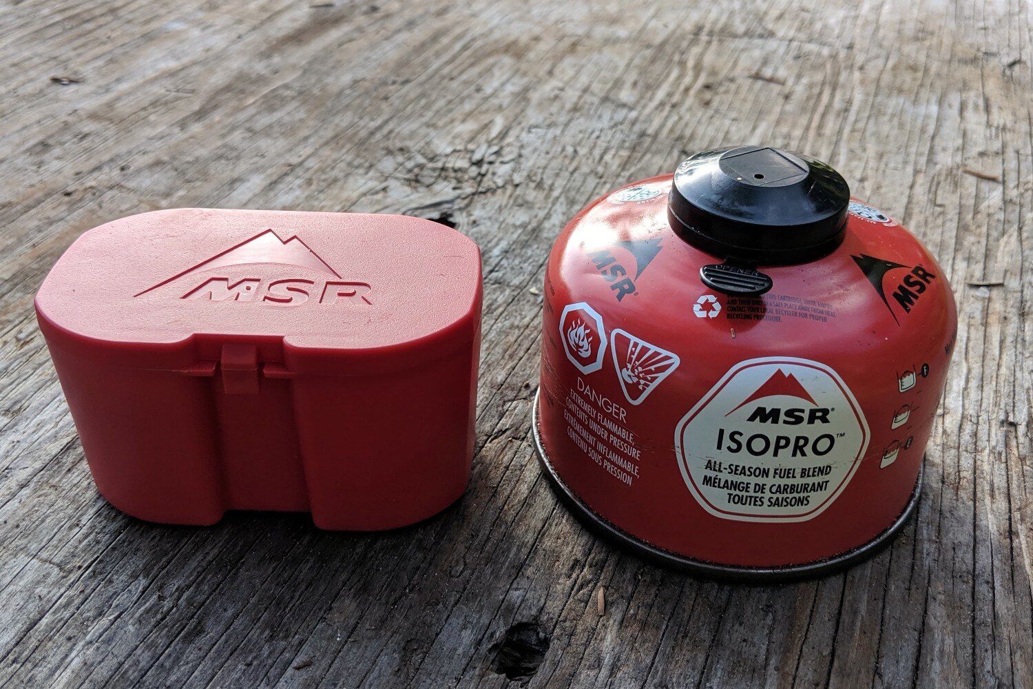 Comparing the size of the Pocket Rocket 2 carrying case with a 110g isobutane fuel canister.