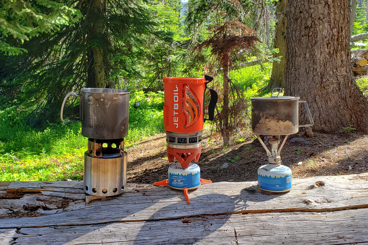 The Solo Stove Lite next to the Jetboil Flash and MSR Pocket Rocket Stoves for comparison.