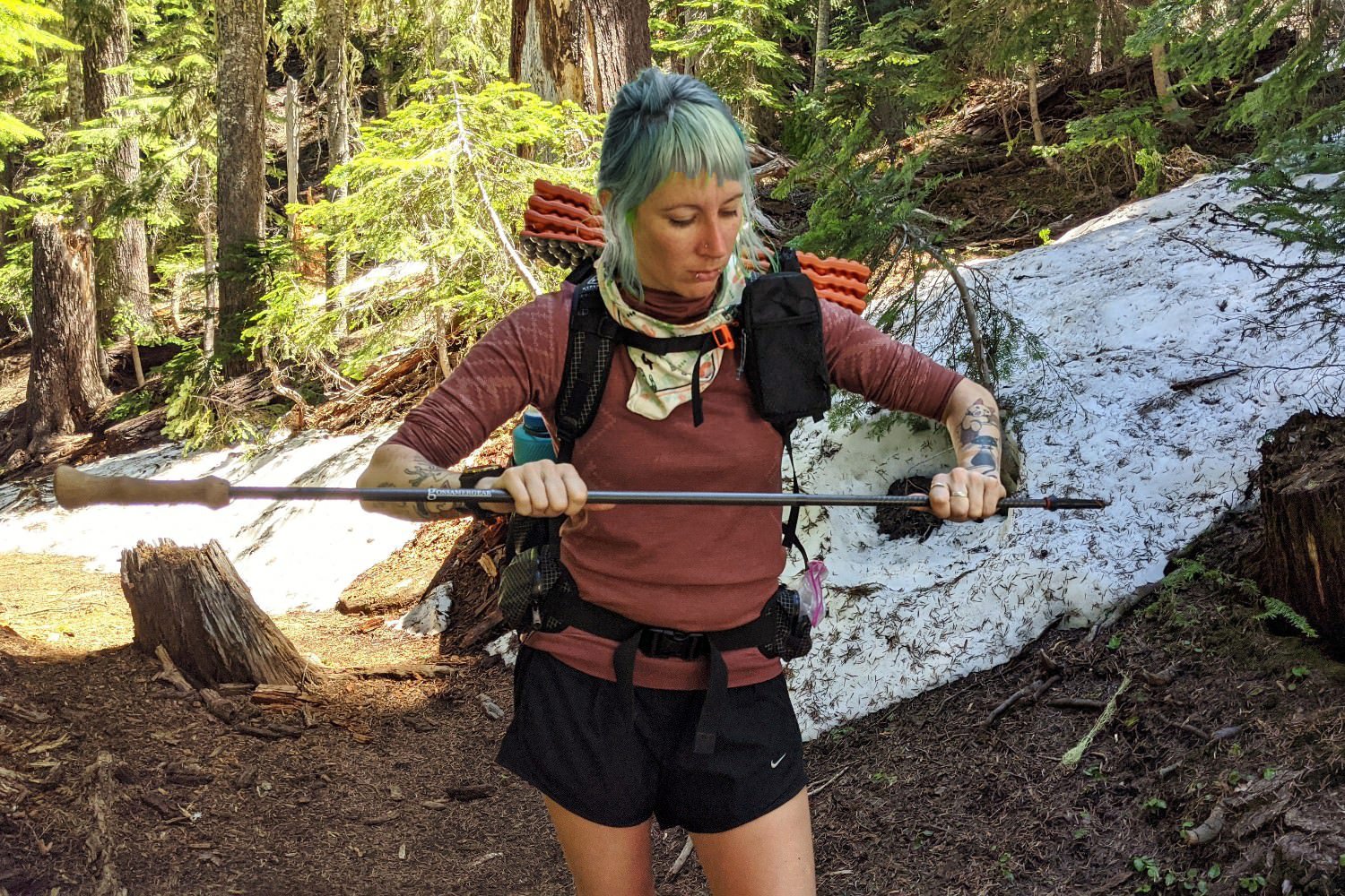 A backpacker twisting together the Gossamer Gear LT5 trekking poles