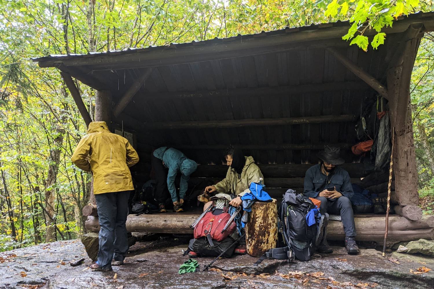 A bunch of Long Trail hikers waiting out some rain in a shelter