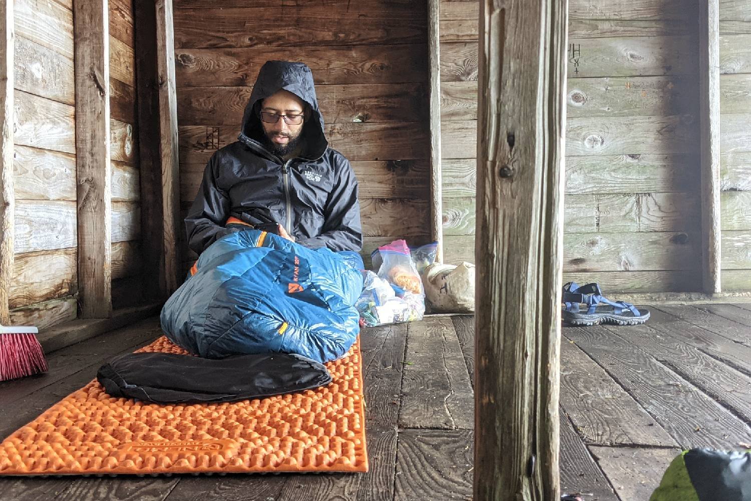 A Long Trail hiker sitting on the NEMO Switchback in a shelter