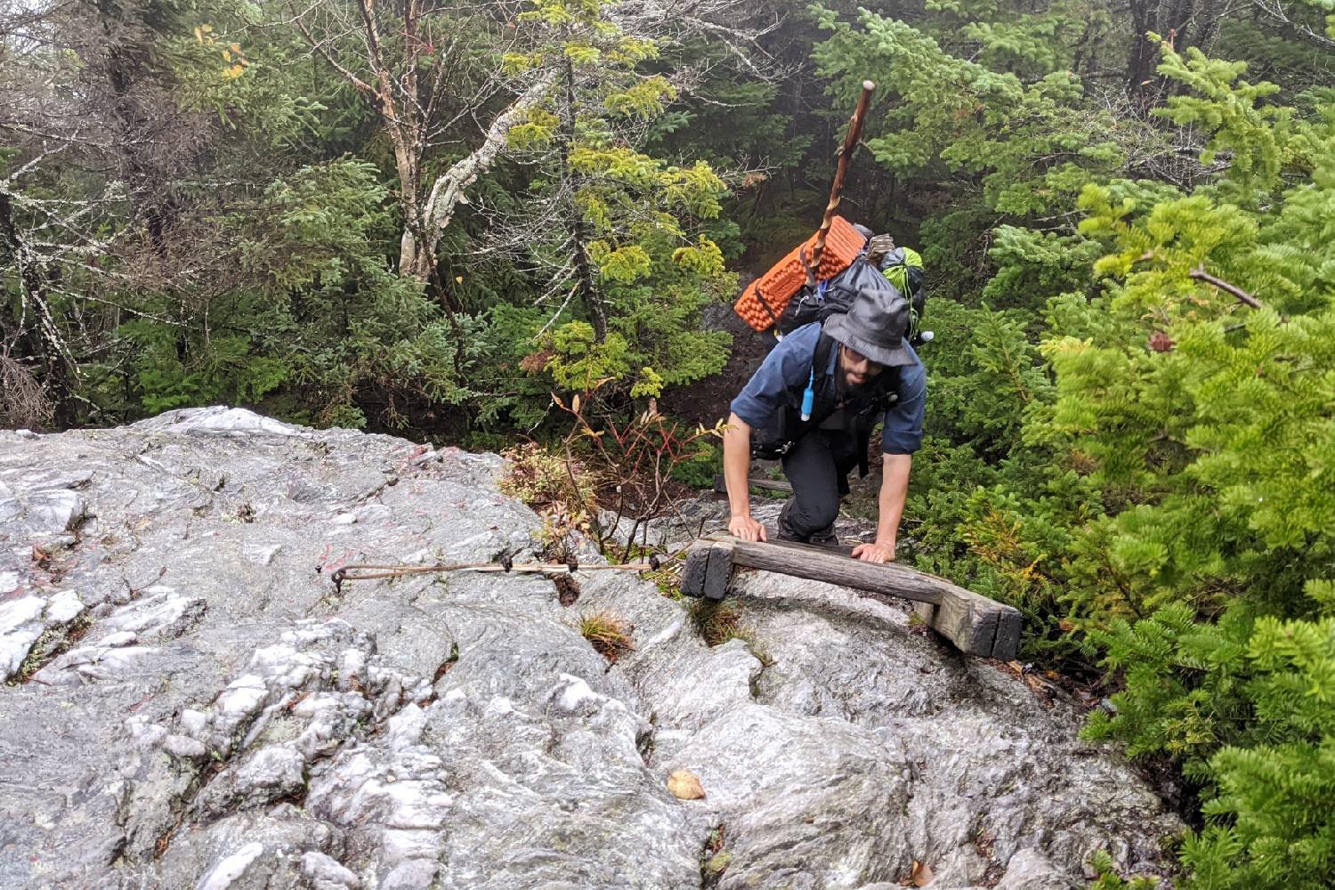 A Long Trail hiker climbing up a ladder