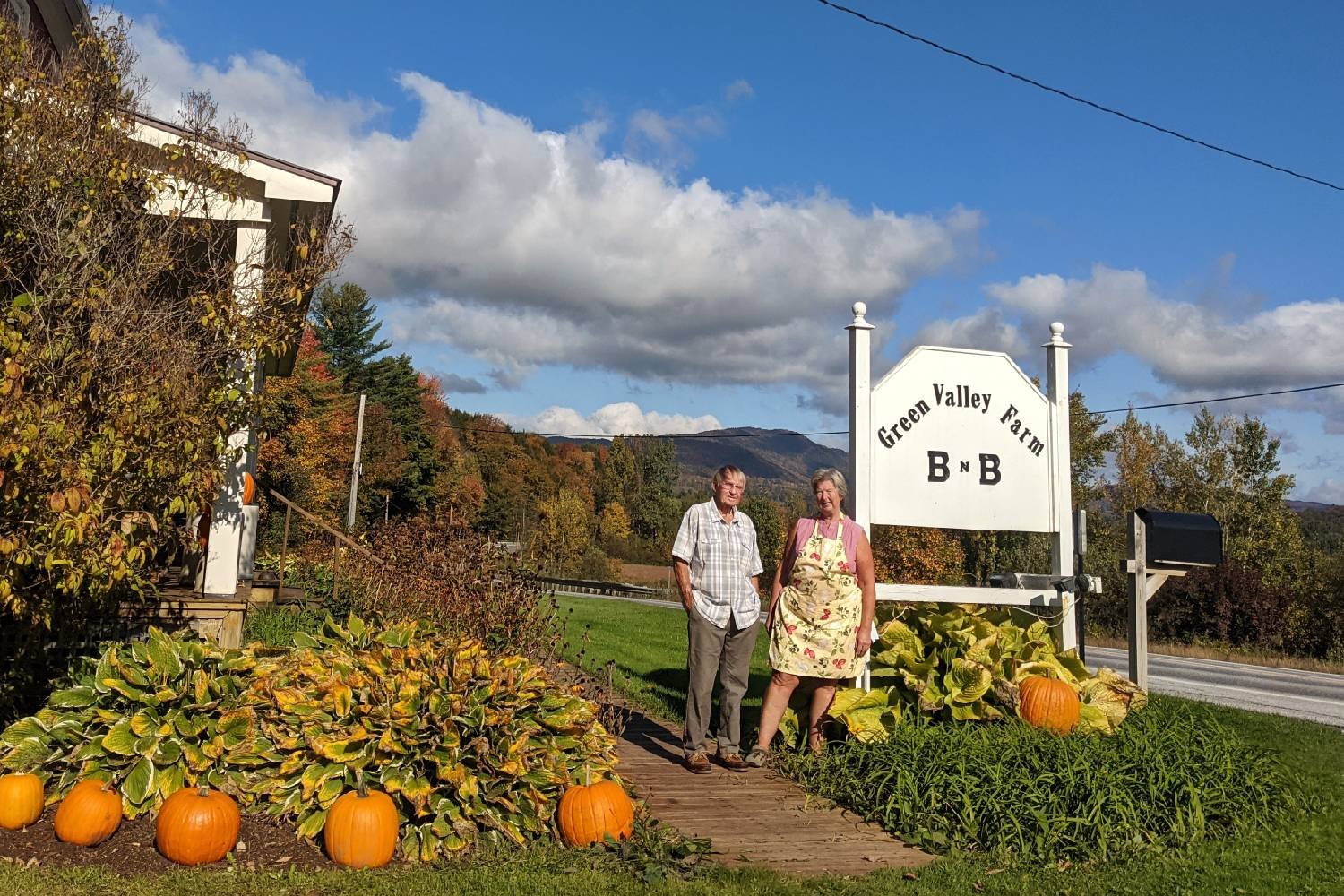Owners Marsha and David Nye with the Green Valley Farm B and B sign