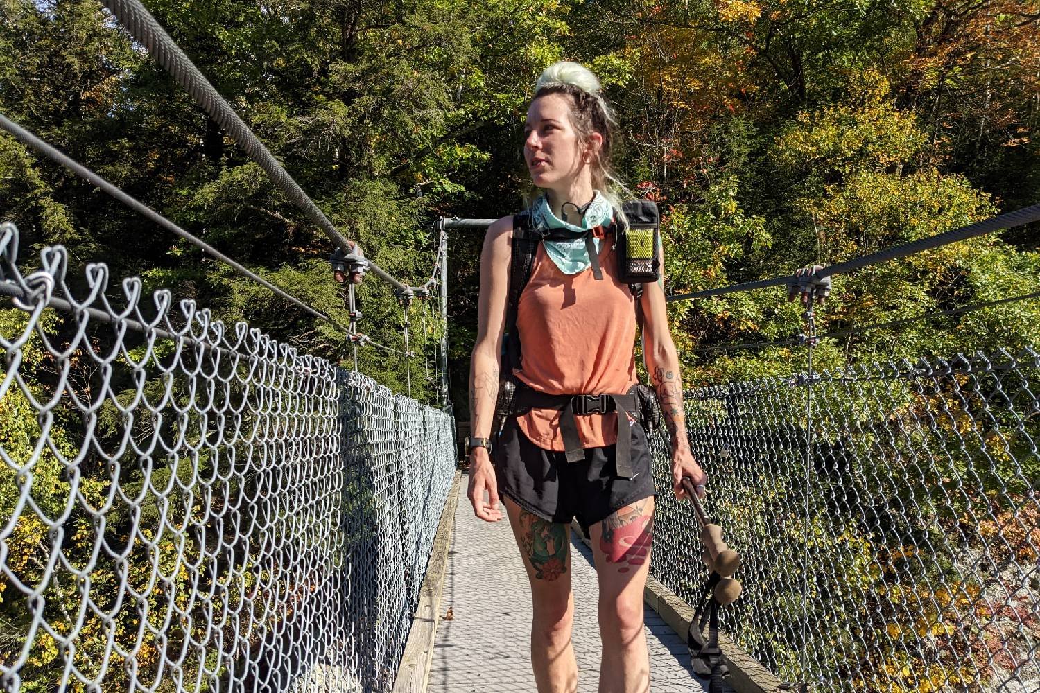A hiker walking on a bridge on the Long Trail