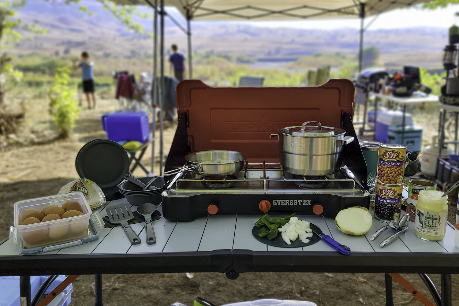 The Stanley Adventure Base Camp 4 Cookset with the Camp Chef Everest 2x stove on a table in a campsite