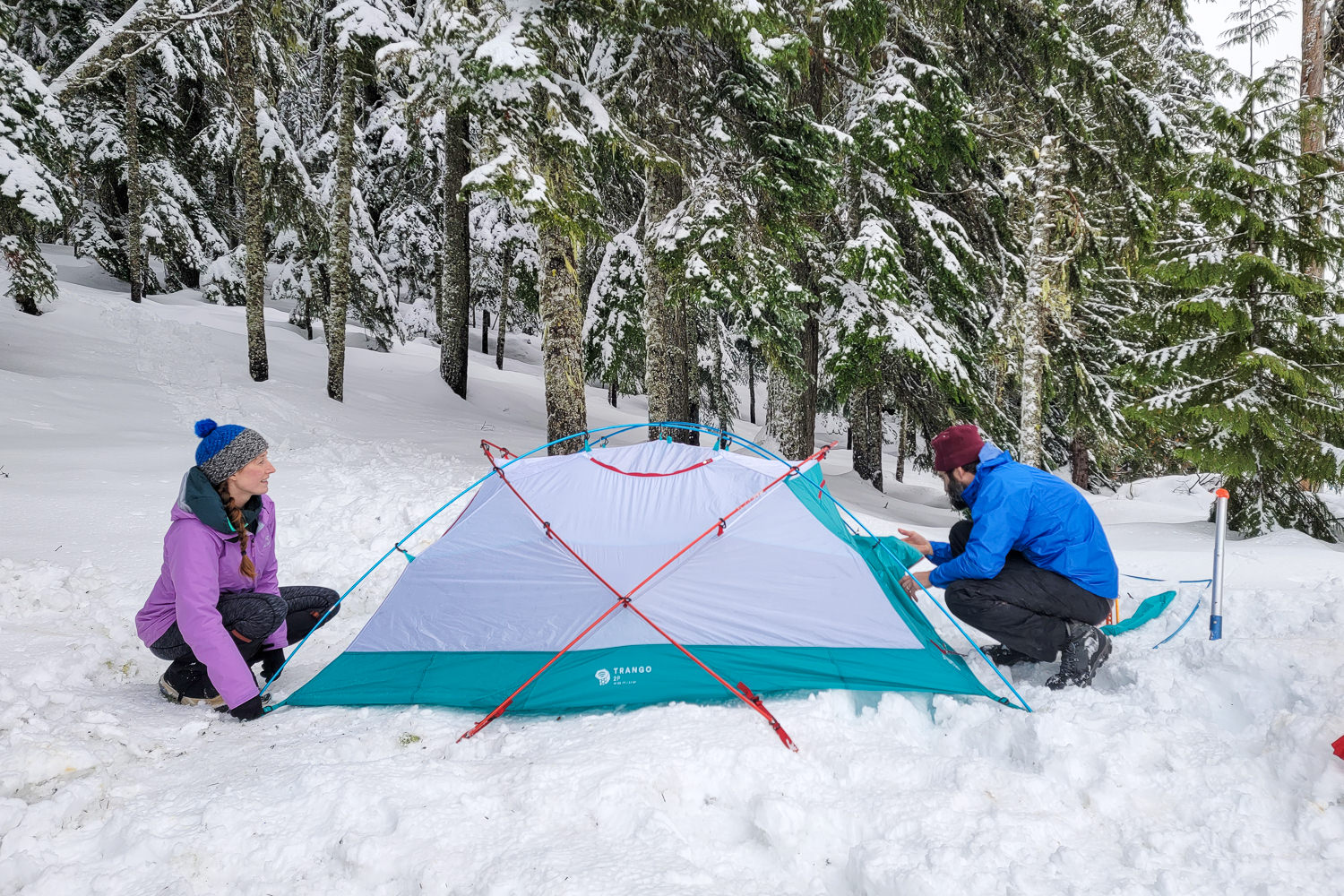 A couple setting up the Mountain Hardwear Trango 2 winter camping tent