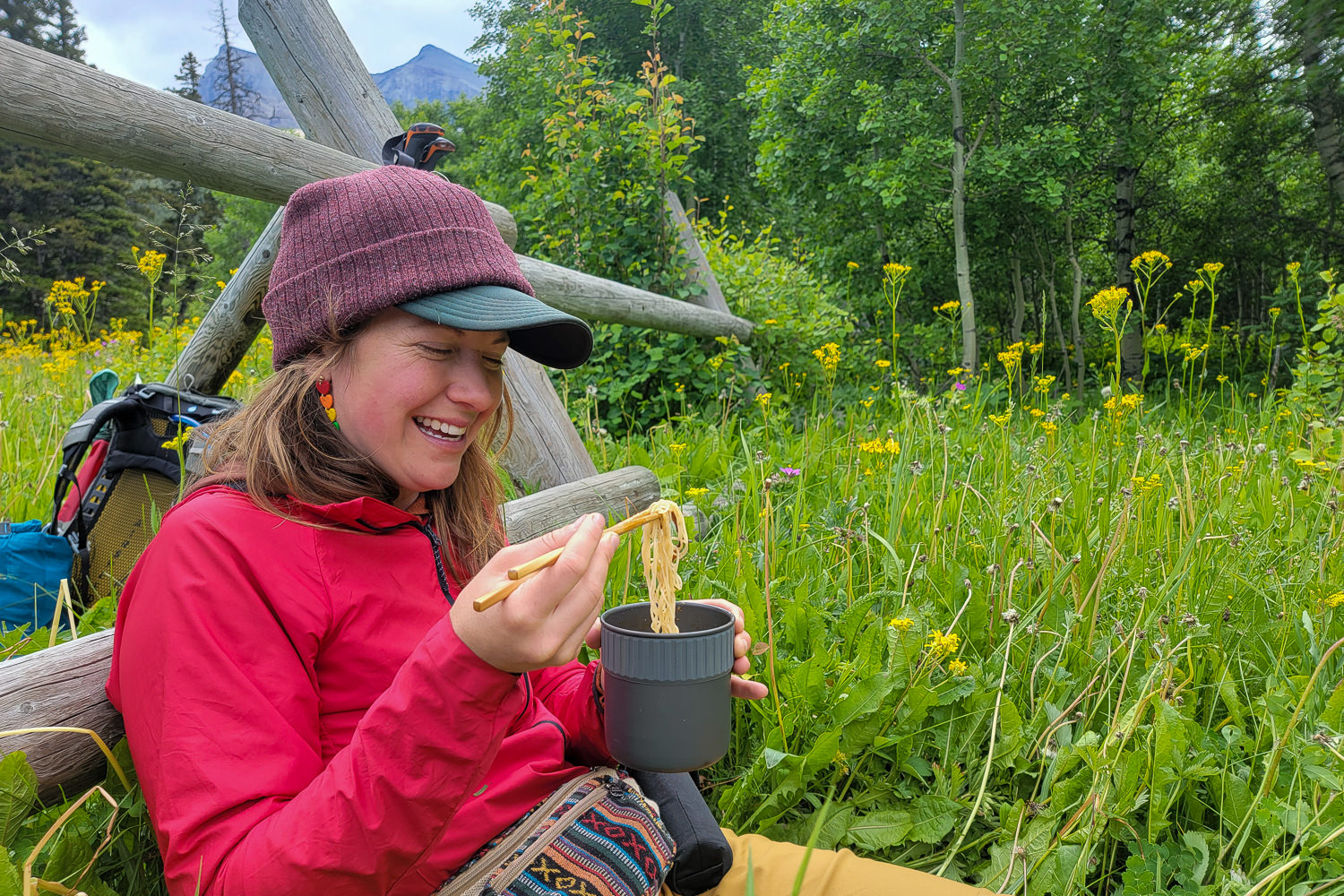 A backpacker eating noodles out of the MSR PocketRocket 2 Mini pot