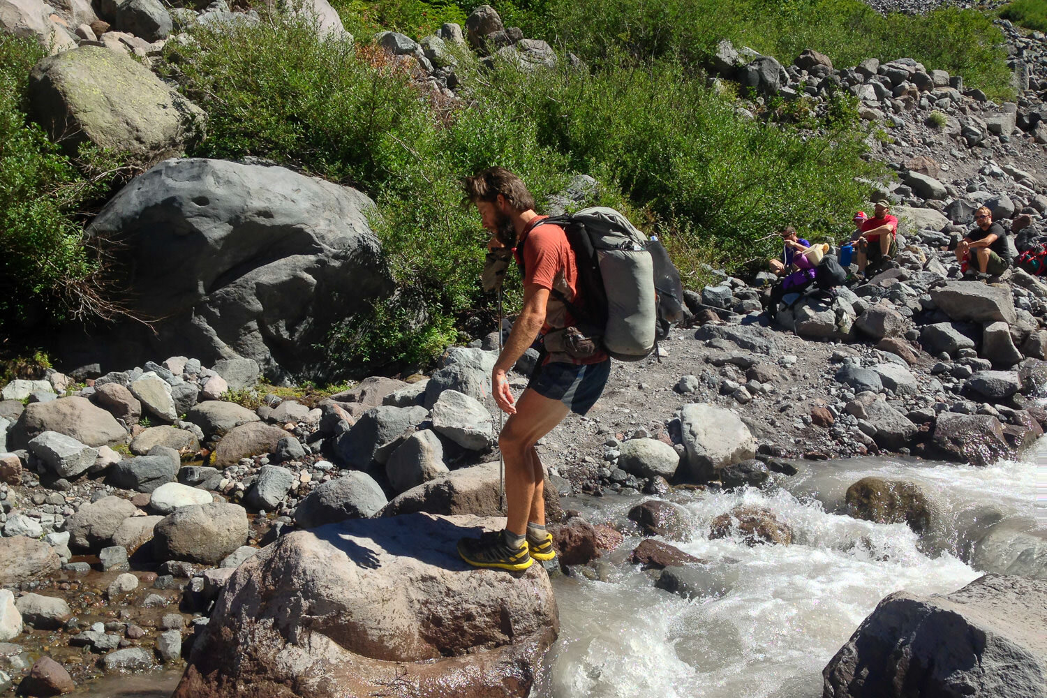 A Hiker jumps across a creek in Northern California