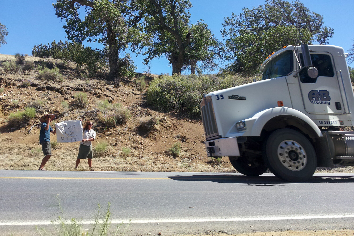 Hikers attempting to hitch a ride into Tehachapi, Ca with a “Hugs for Rides” sign (it worked)