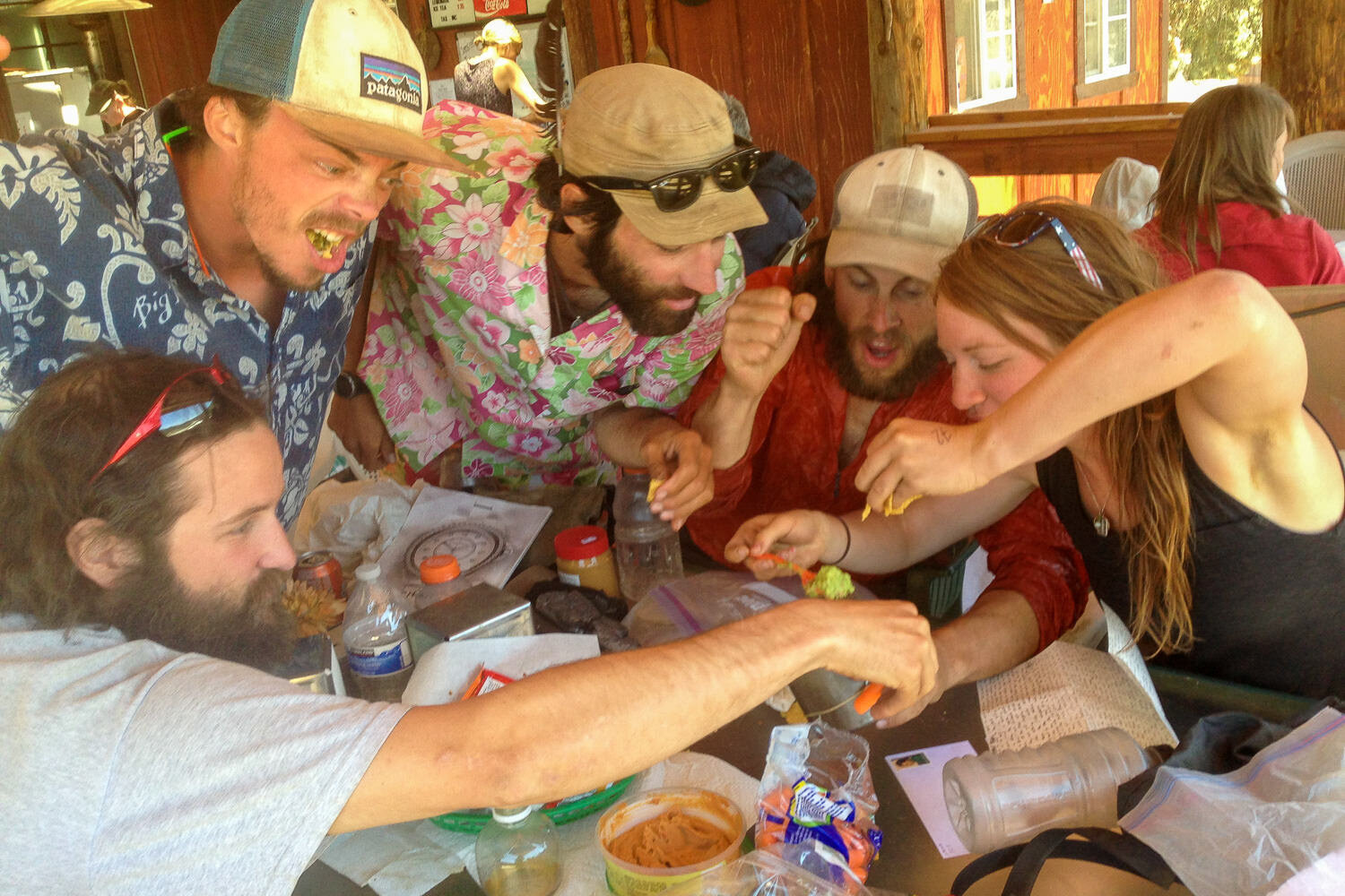 Thru-Hikers Ferociously eating in Kennedy Meadows