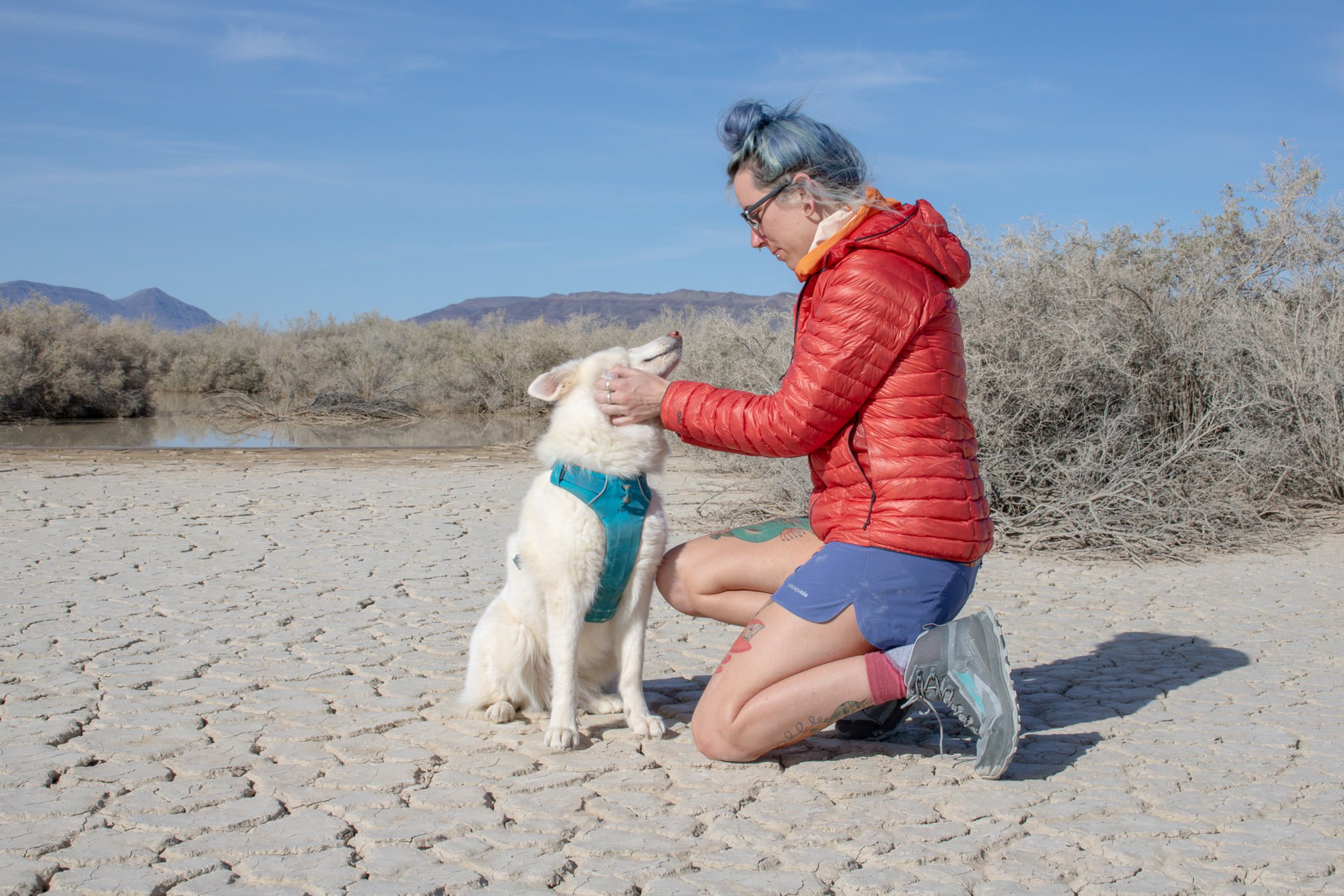 A woman dressed in shorts and a down jacket in the Alvord Desert