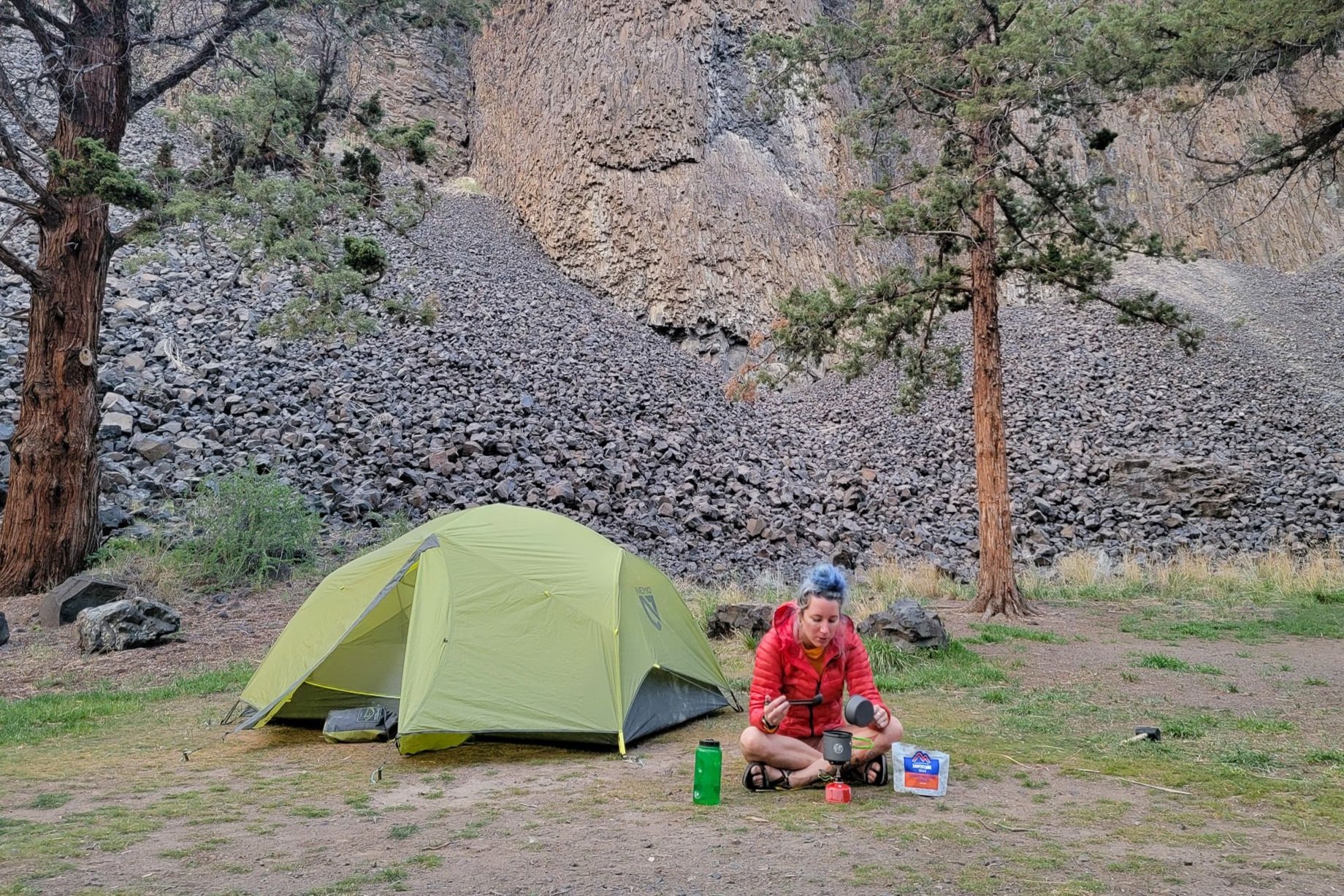 a hiker sitting in front of the NEMO Dagger OSMO