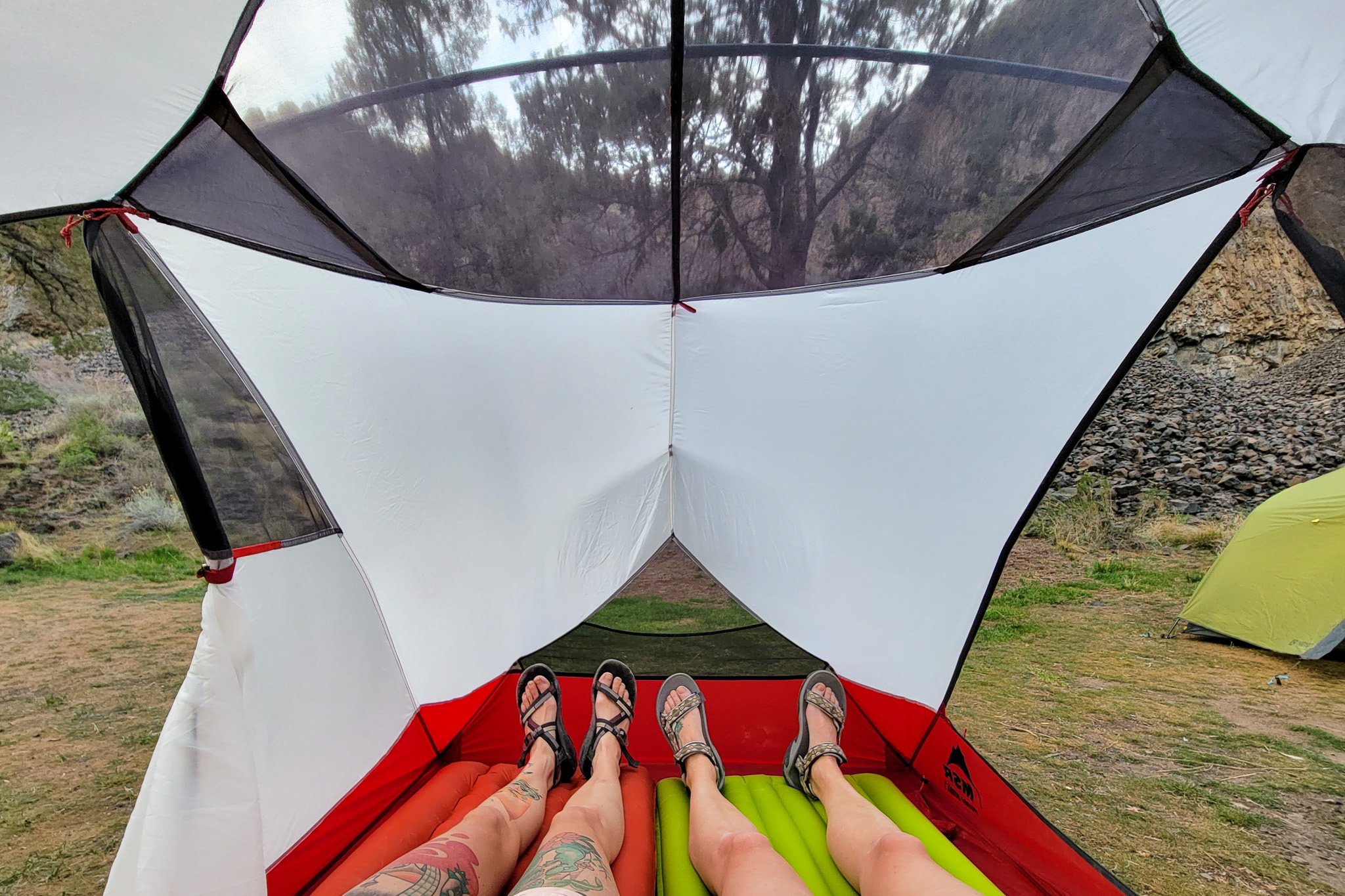 Two hikers laying in the MSR Hubba Hubba 2 tent