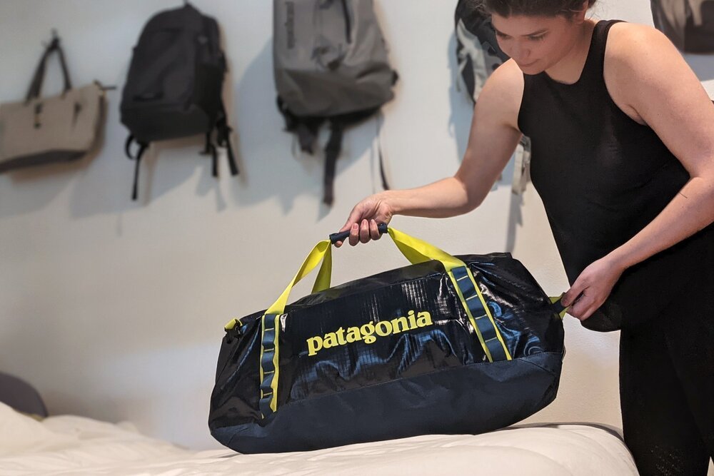 A woman holding the Patagonia Black Hole Duffel Bag