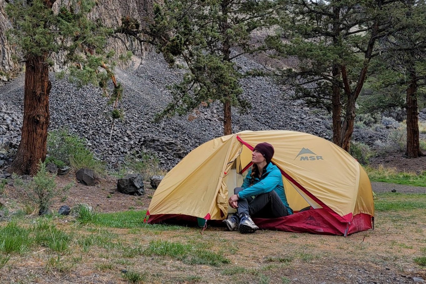 A hiker sitting in the doorway of the MSR Hubba Hubba 2 tent