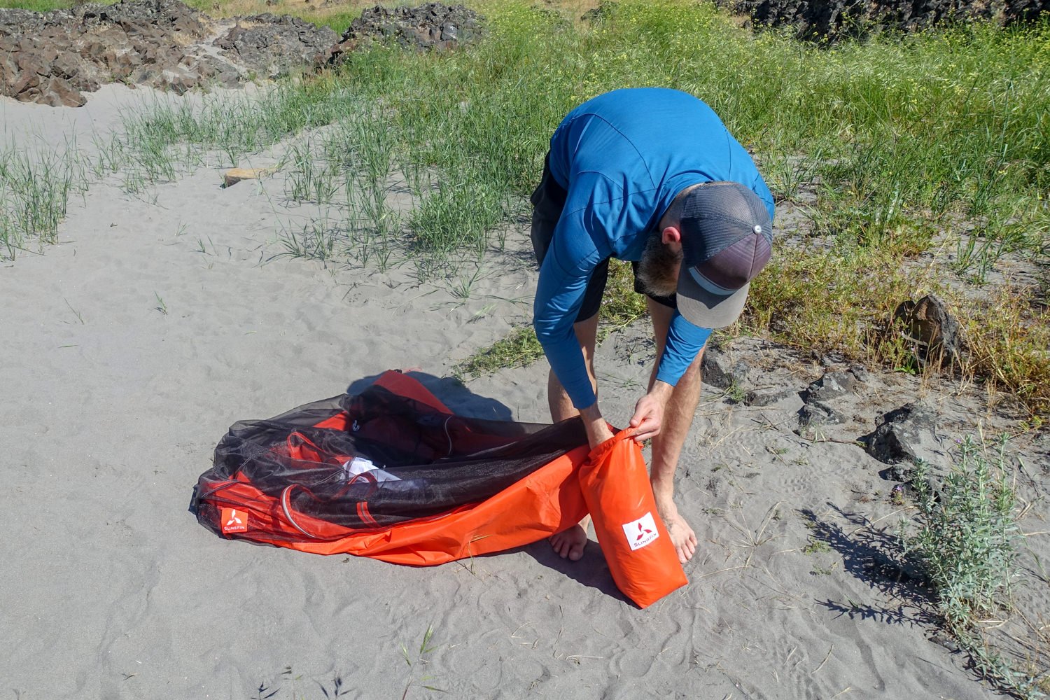 Stuffing the Slingfin Portal tent into its stuff sack