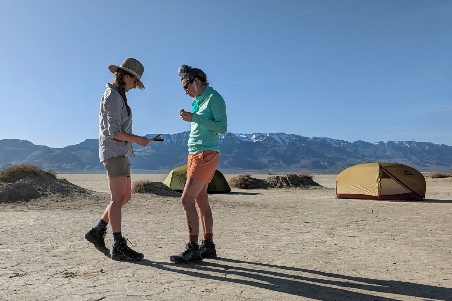 Hikers looking at a map in the Alvord Desert