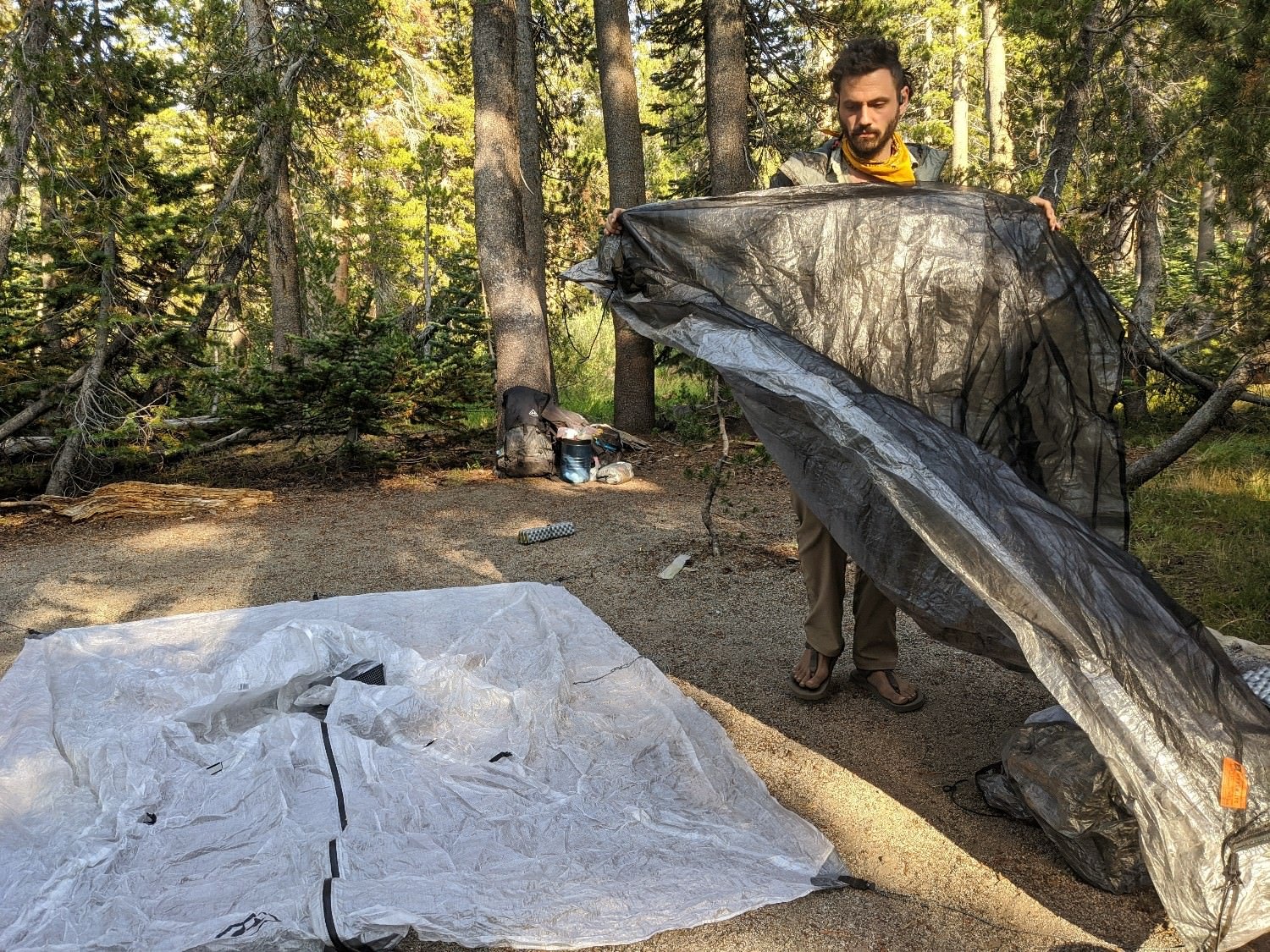 A hiker setting up the Hyperlite Mountain Gear Ultamid 2 tent