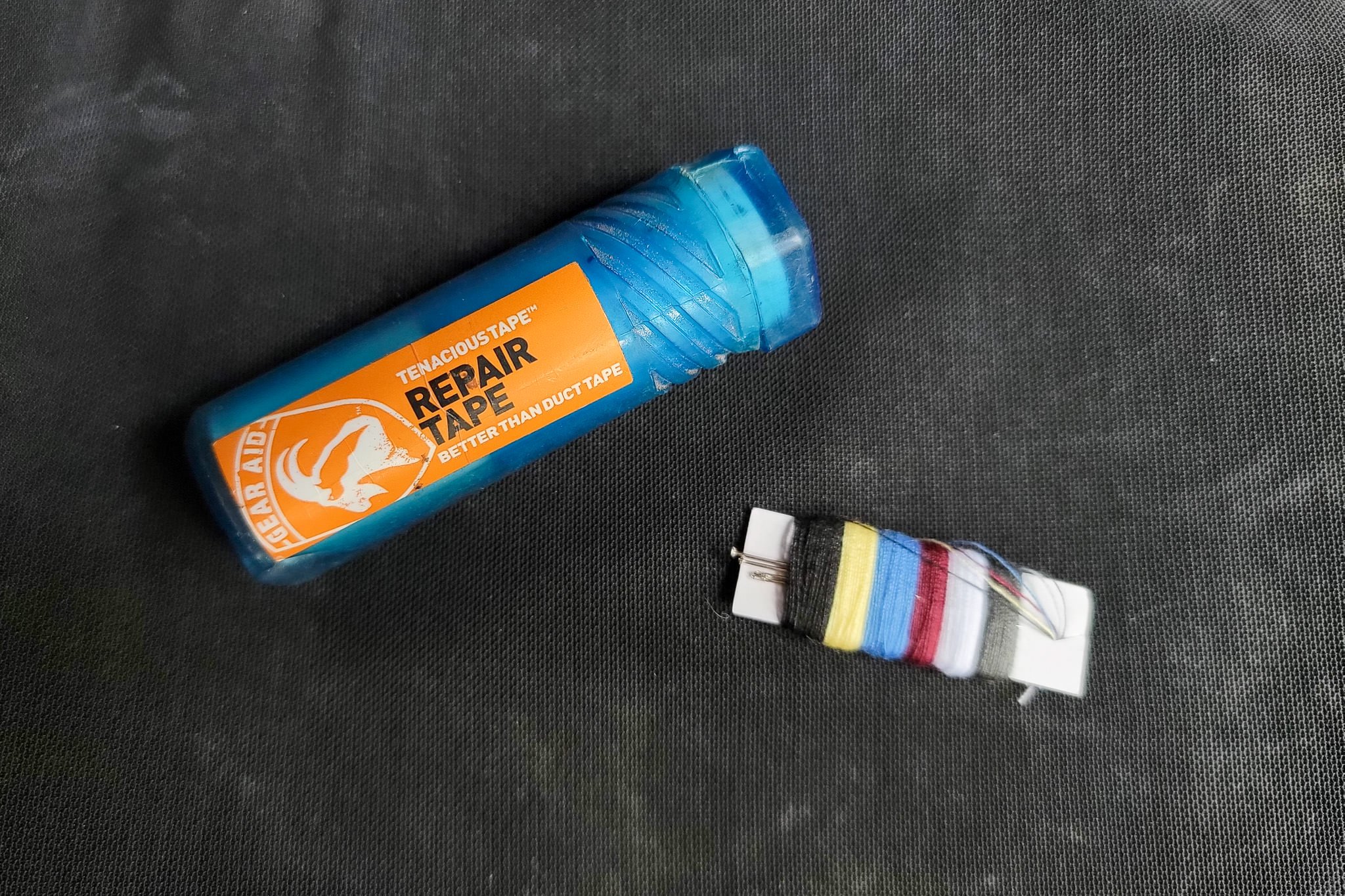 Closeup of Tenacious Tape & a small Sewing kit for tent repairs