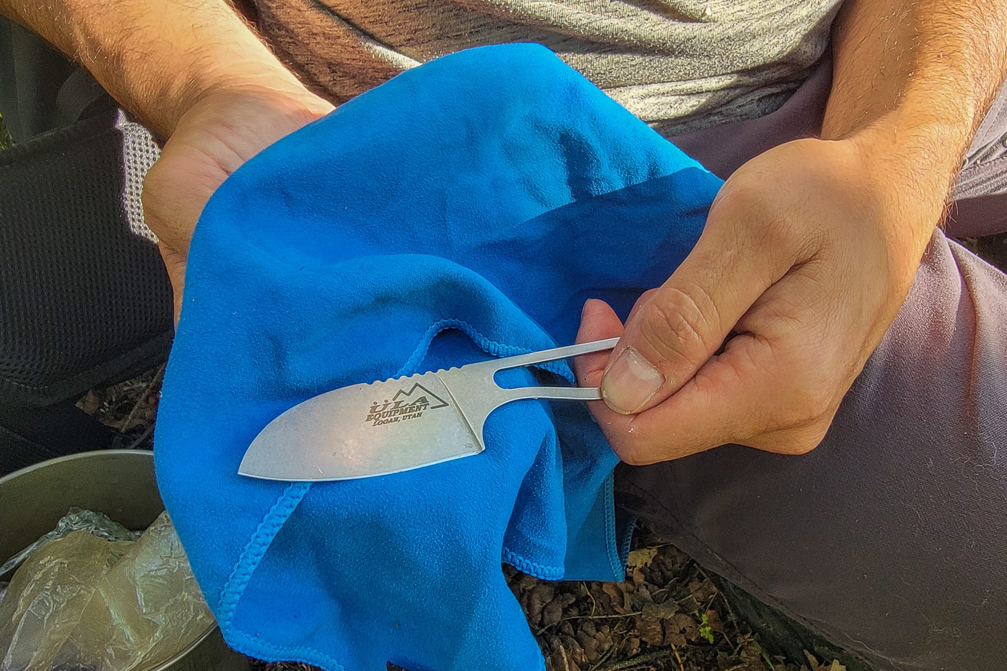 Closeup of the ULA Alpha Knife being wiped down with a cloth