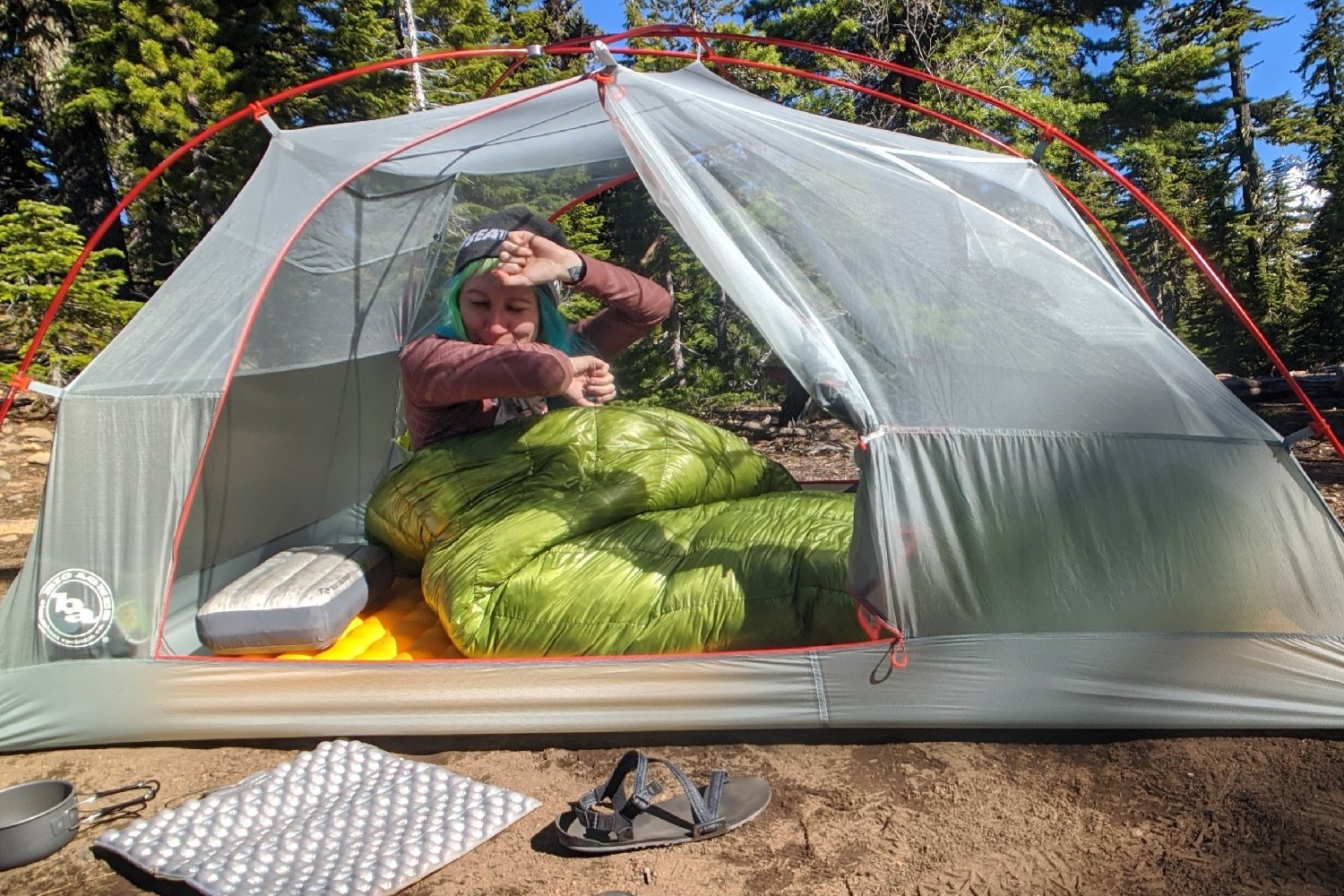 A hiker waking up in a tent in the Zpacks Classic Sleeping Bag