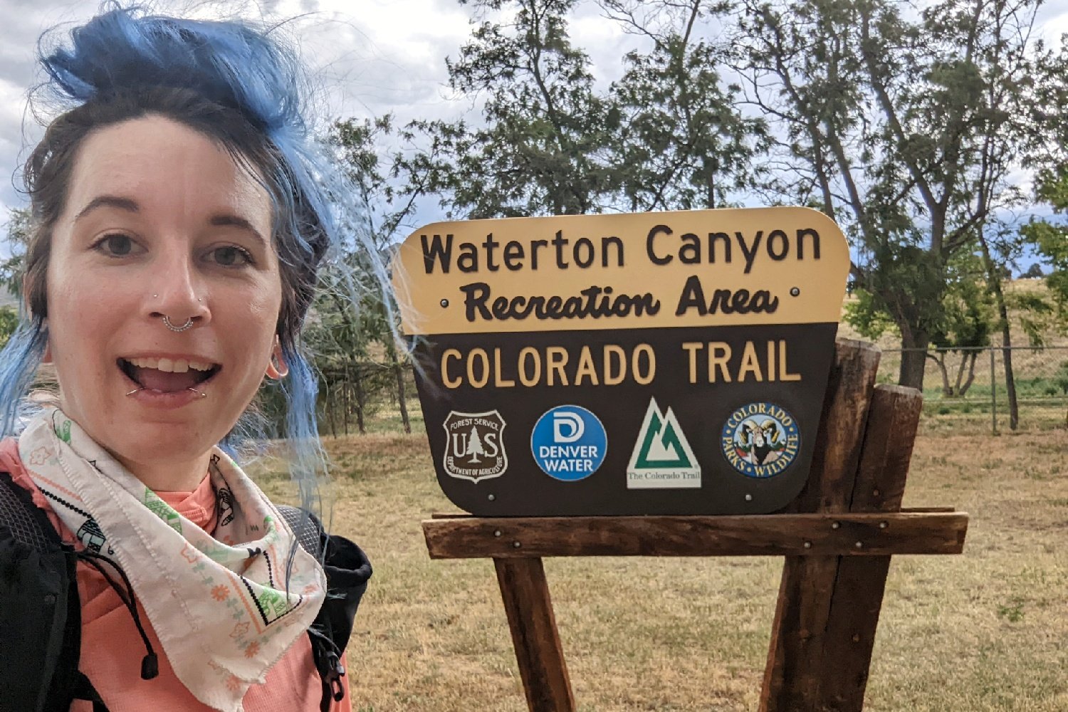 A selfie of a hiker at the Northern Terminus of the Colorado Trail in Waterton Canyon