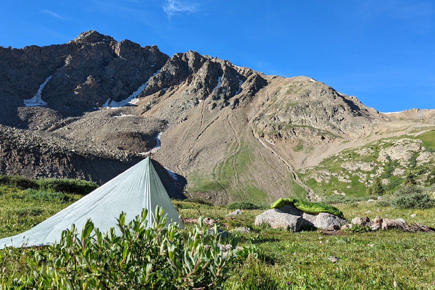The Zpacks 7x9 Flat Tarp set up in front of a mountain