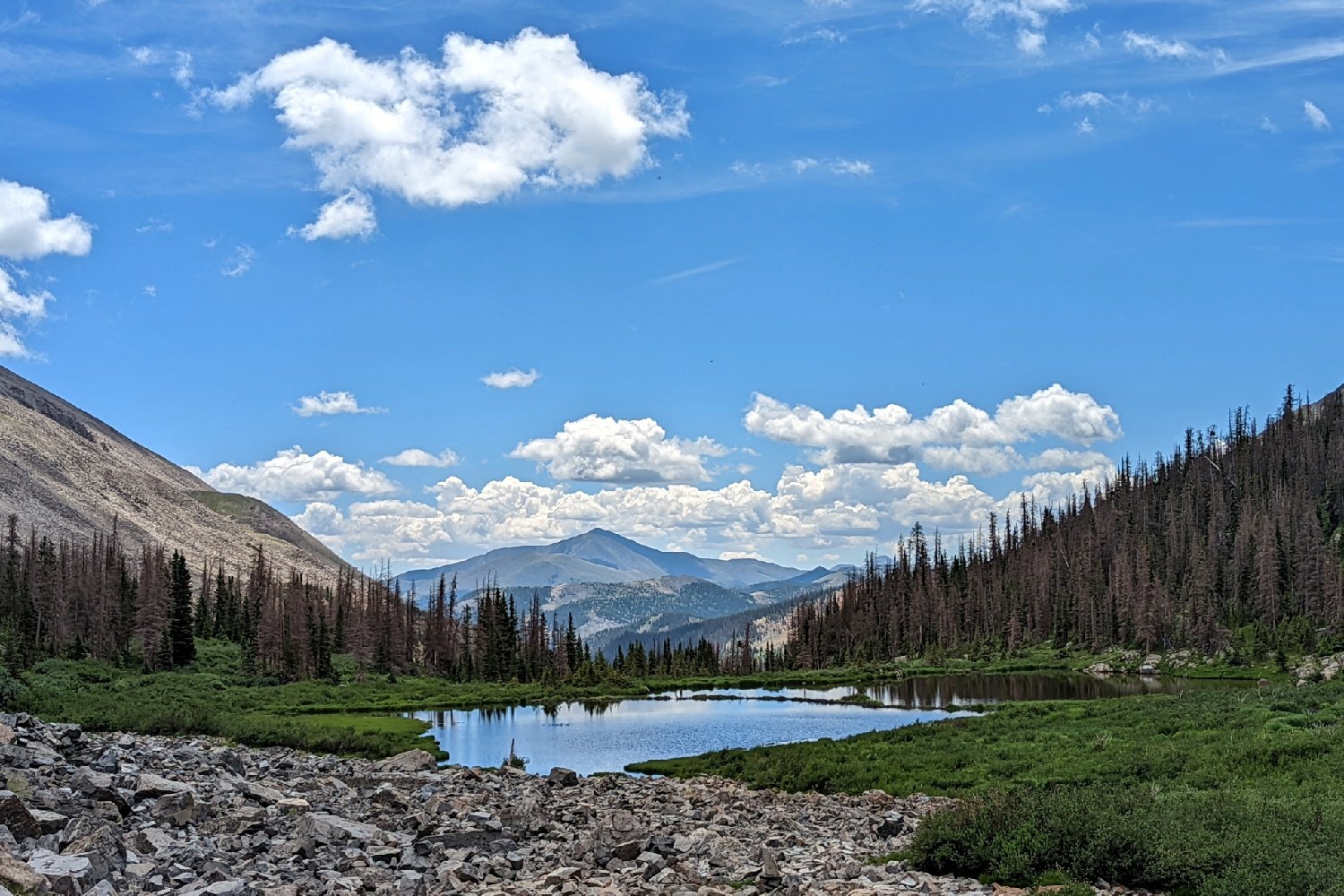 A view of a lake with a mountain in the background on the Colorado Trail