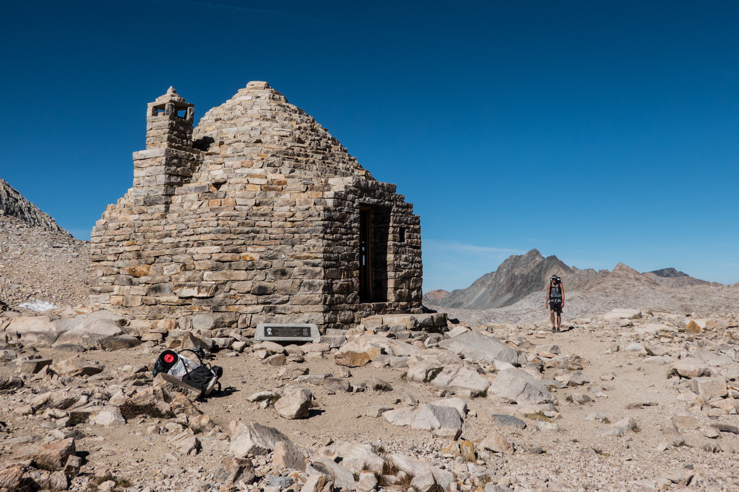 round shelter made from stacked stones on a rocky pass
