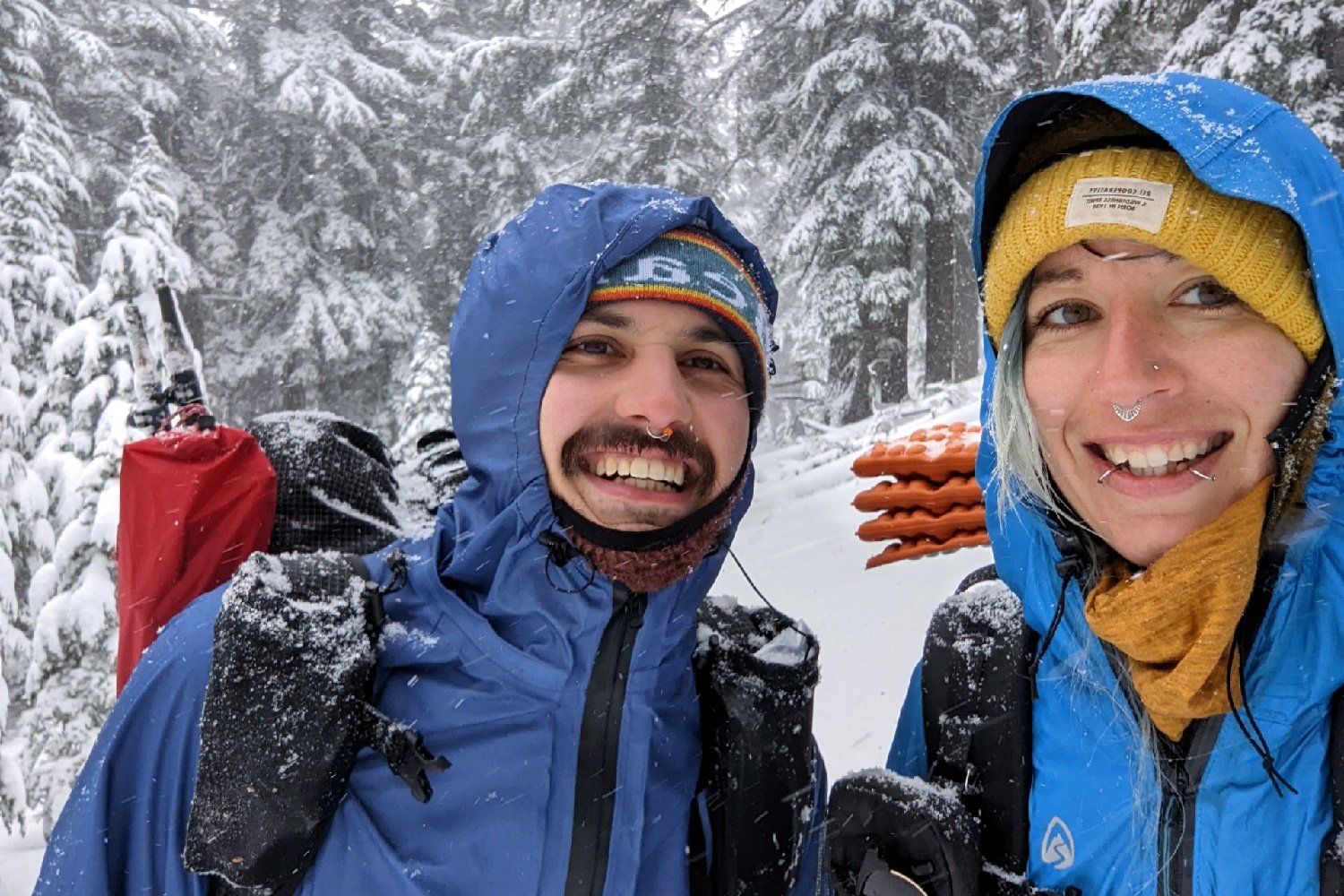 Two hikers wearing the Zpacks Vertice and Enlightened Equipment Visp in the snow