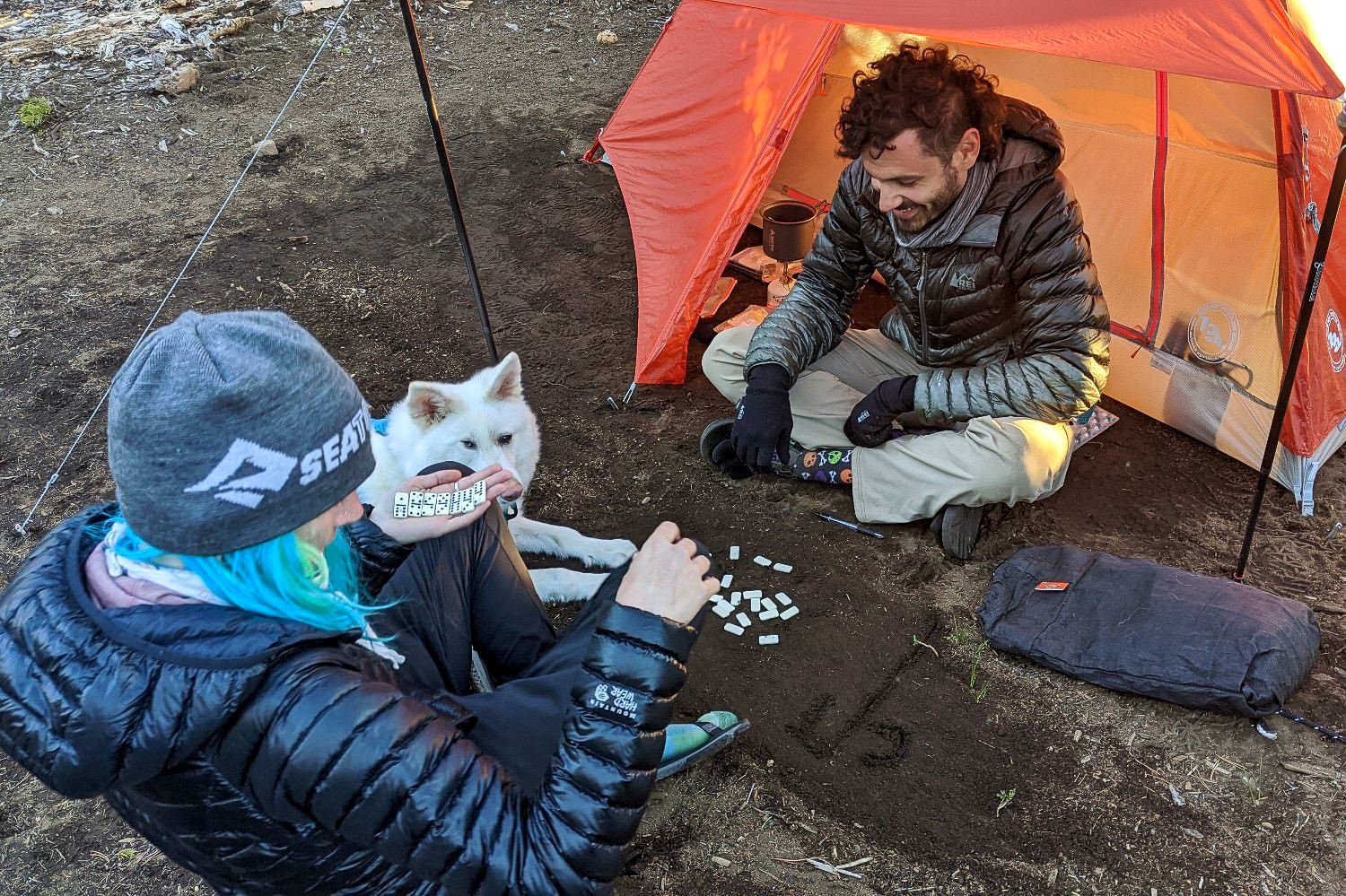 Backpackers playing dominos outside of the Big Agnes Copper Spur in November