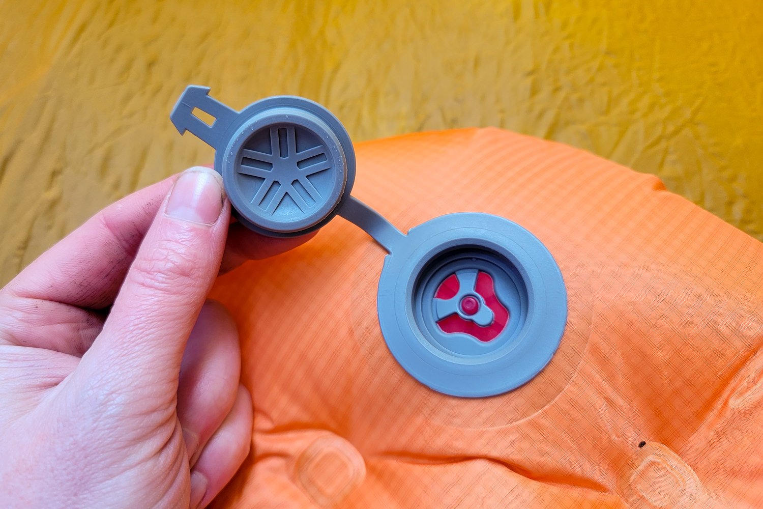 the valve on the Big Agnes Zoom Ultralight sleeping pad opened to show that the inside has a button to adjust firmness.