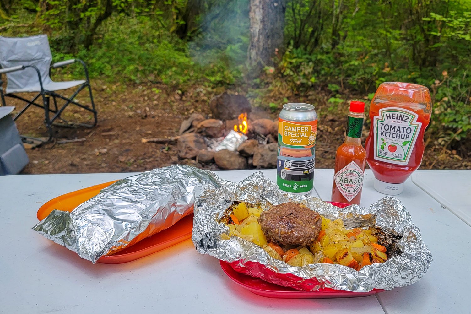 Classic foil packet meal with beer, hot sauce, and ketchup