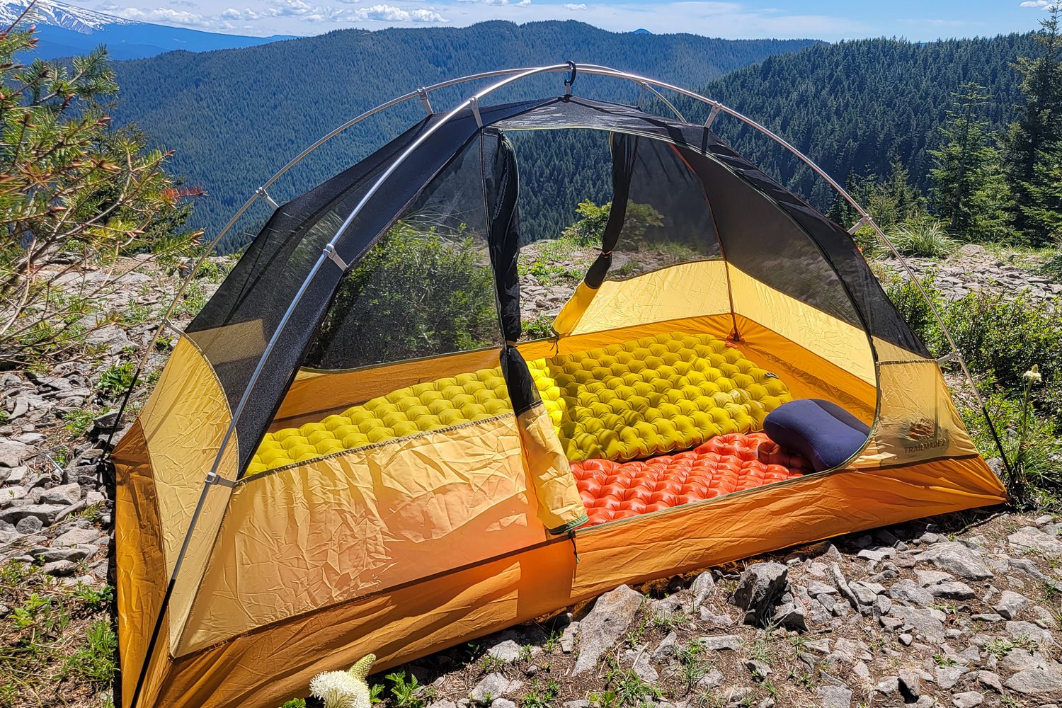 If you looking into the inside of the REI Trailmade 2 tent with both doors opened and sleeping pads on the floor of the tent