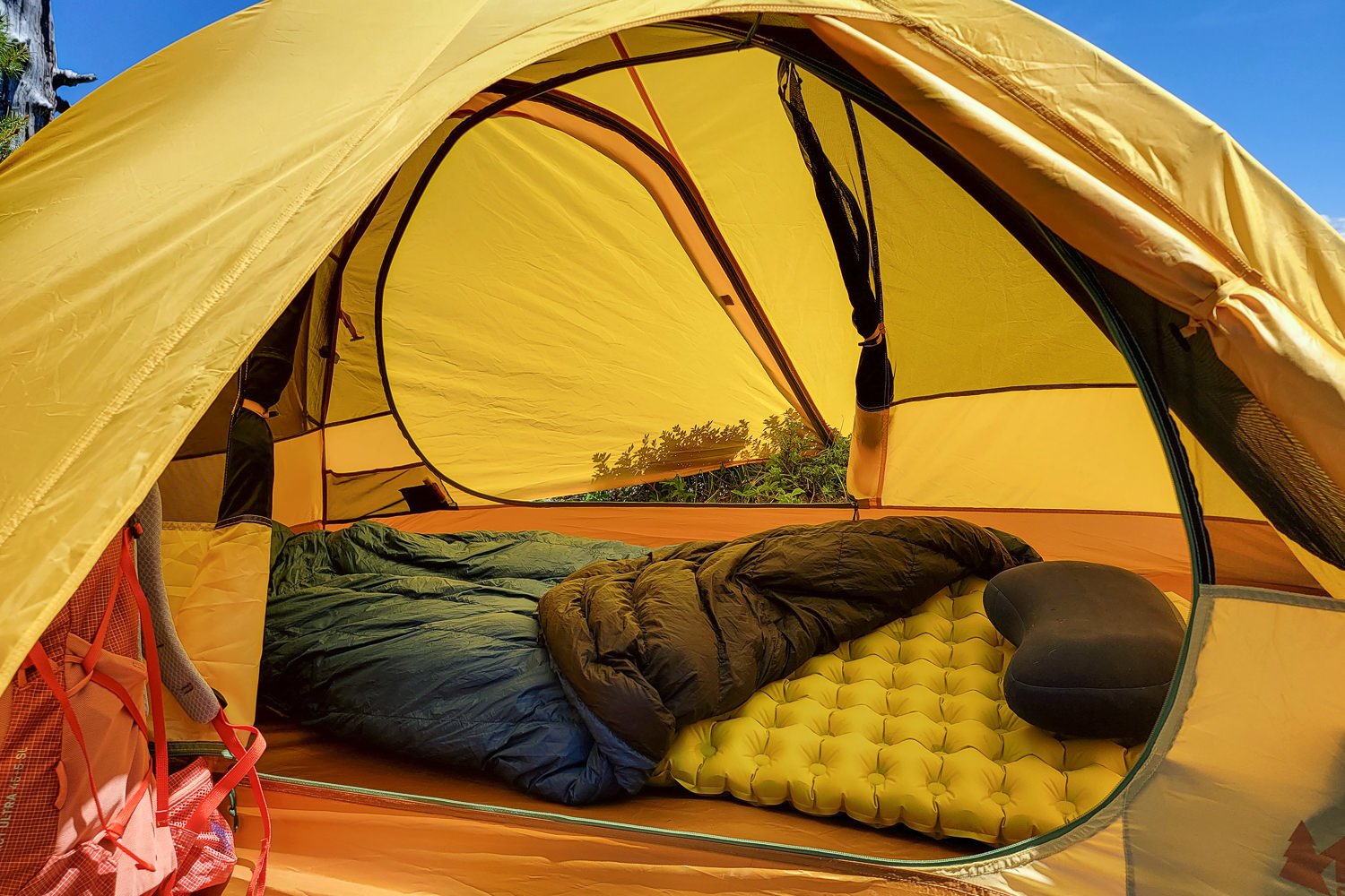 An interior view of the Trailmade 2 tent with both doors open and a sleeping bag and sleeping pad on the inside