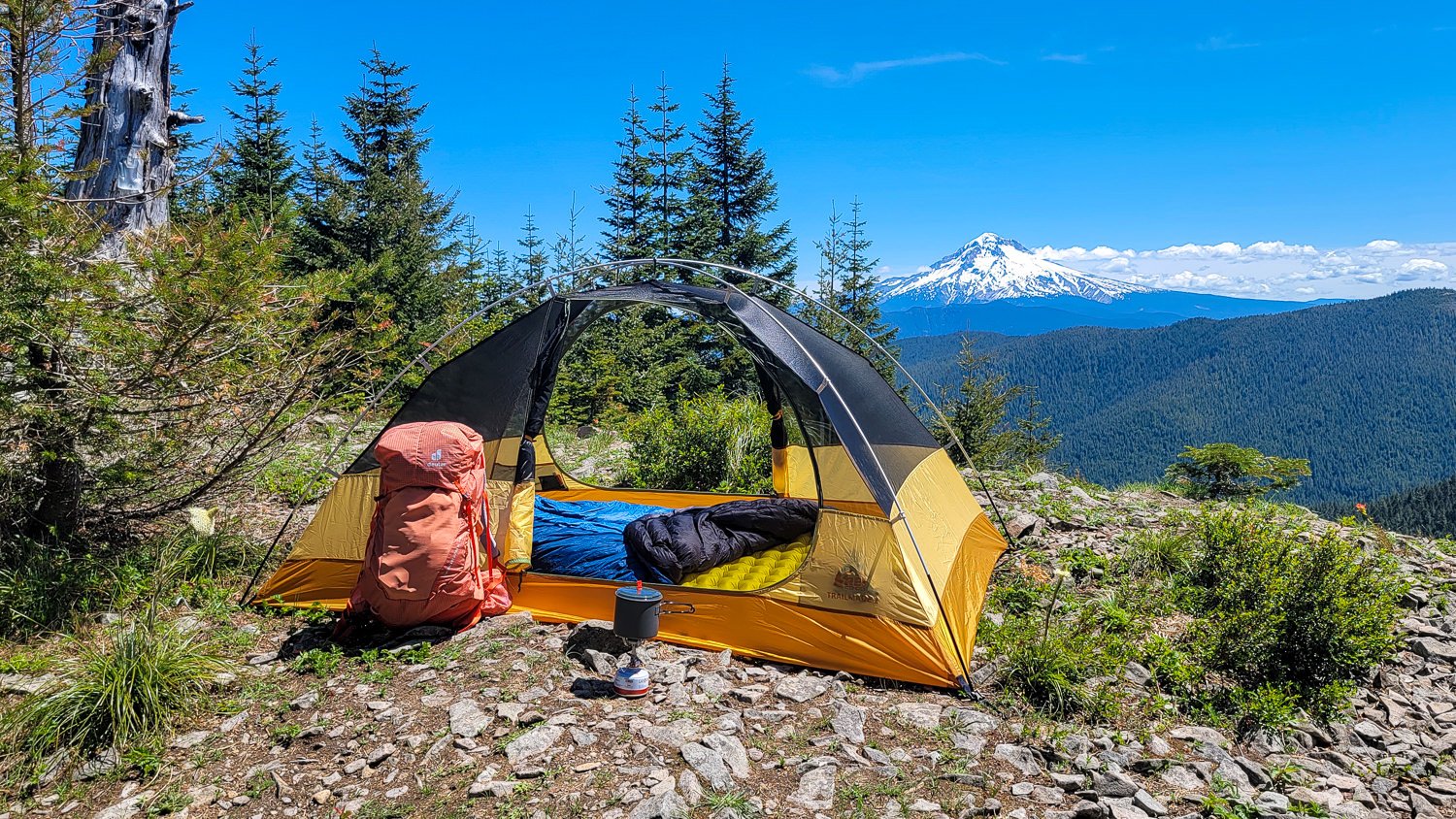 The REI Trailmade 2 tent set up for camping on a high ridge with Mount Hood in the background
