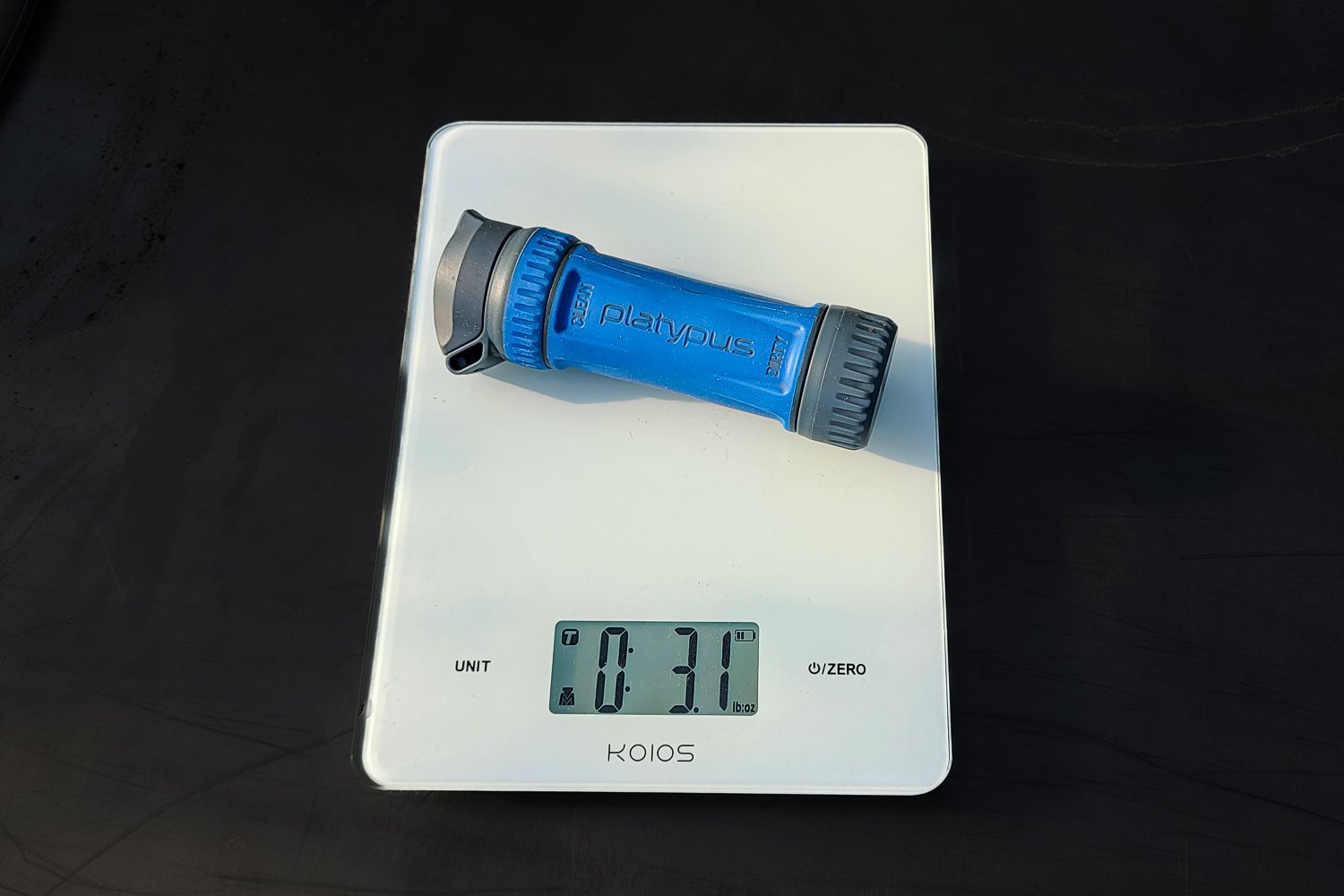 The Platypus QuickDraw filter cartridge on a scale that reads '3.1 oz.'