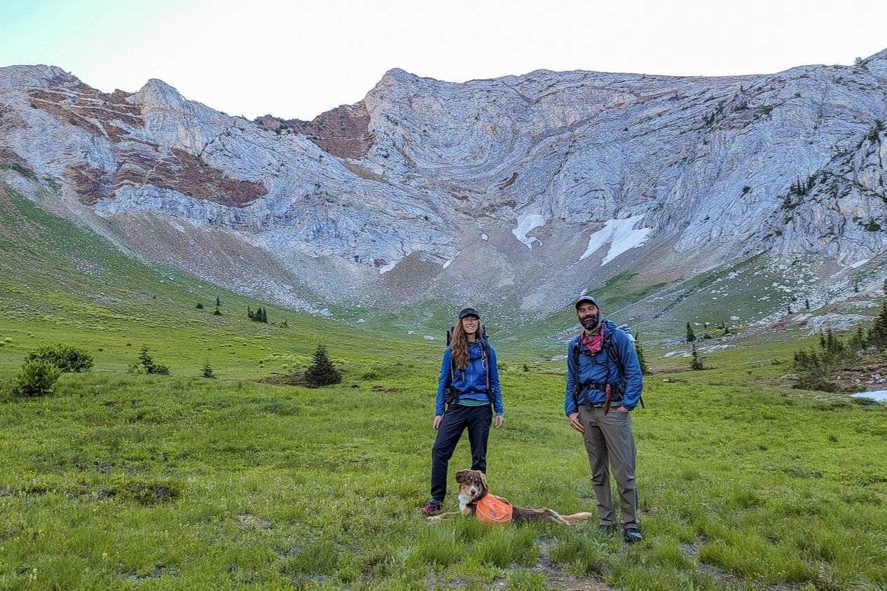 Male and female backpackers both wearing Patagonia Houdini Windbreaker Jackets