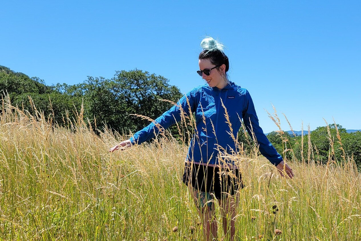 The Patagonia Houdini (men’s / women’s) has a slim fit so it works best over thin layers - we’re wearing it over a sun shirt for this hike